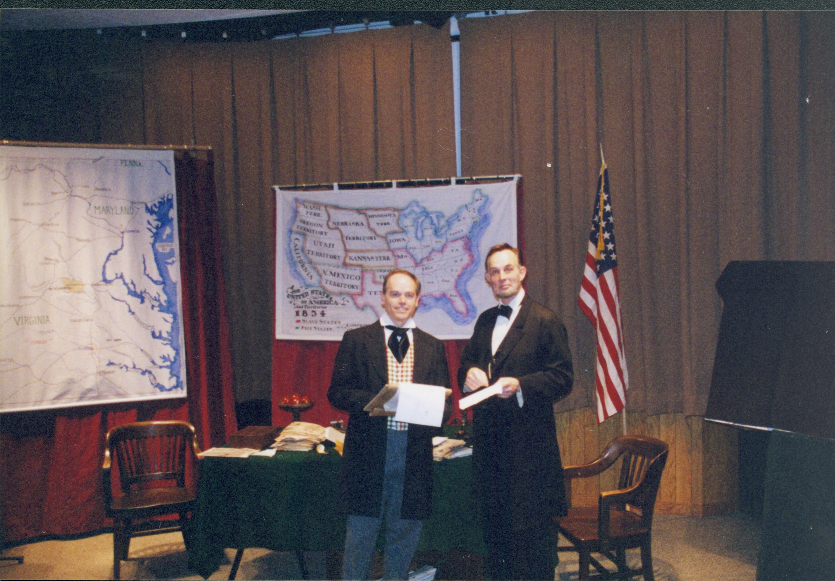 Two men in period dress standing in front of U.S. map. Lincoln Home NHS- Fritz Klein and Drew Gibson visit, roll 2002-1, exp 12 Klein, Gibson, visit
