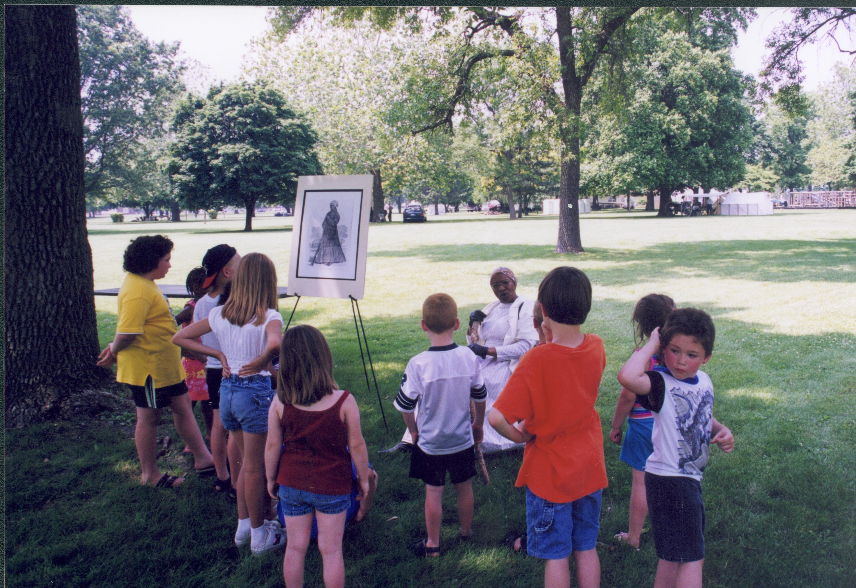 Children listening to lady seated in period dress. Lincoln Home NHS- Grierson Days Jacksonville Grierson, Jacksonville, celebration