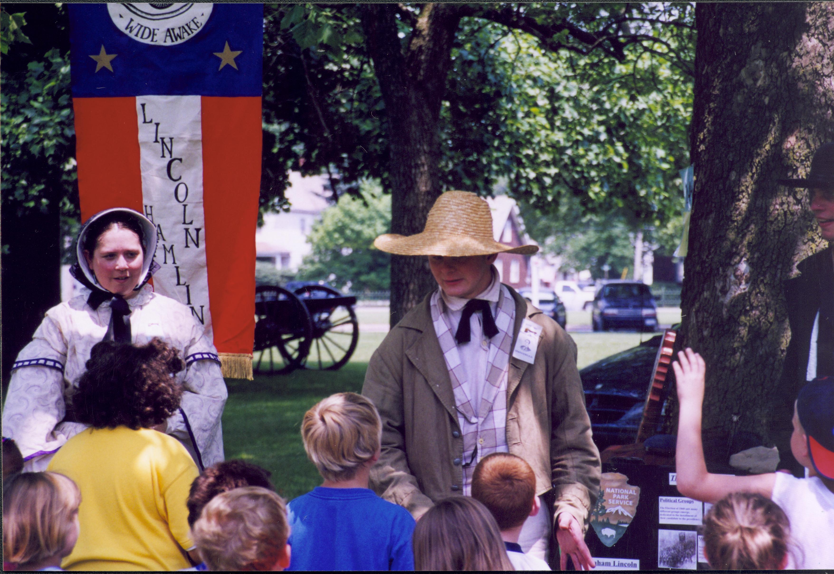 Children with two in period dress in front of banner. Lincoln Home NHS- Grierson Days Jacksonville Grierson, Jacksonville, celebration