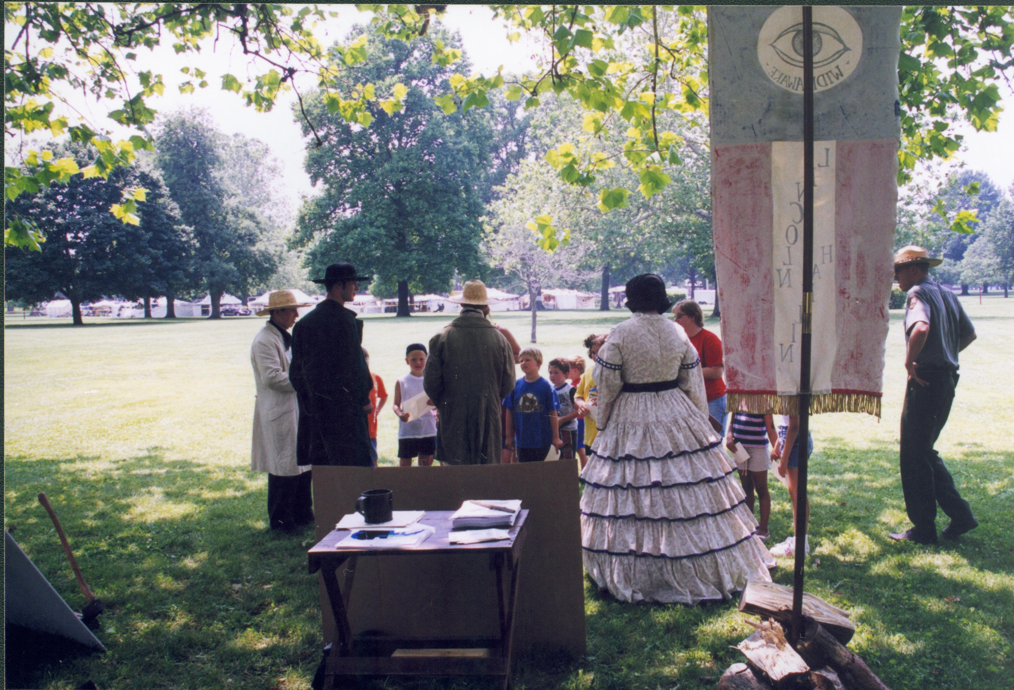 Looking from behind period dress enactees at children. Lincoln Home NHS- Grierson Days Jacksonville Grierson, Jacksonville, celebration