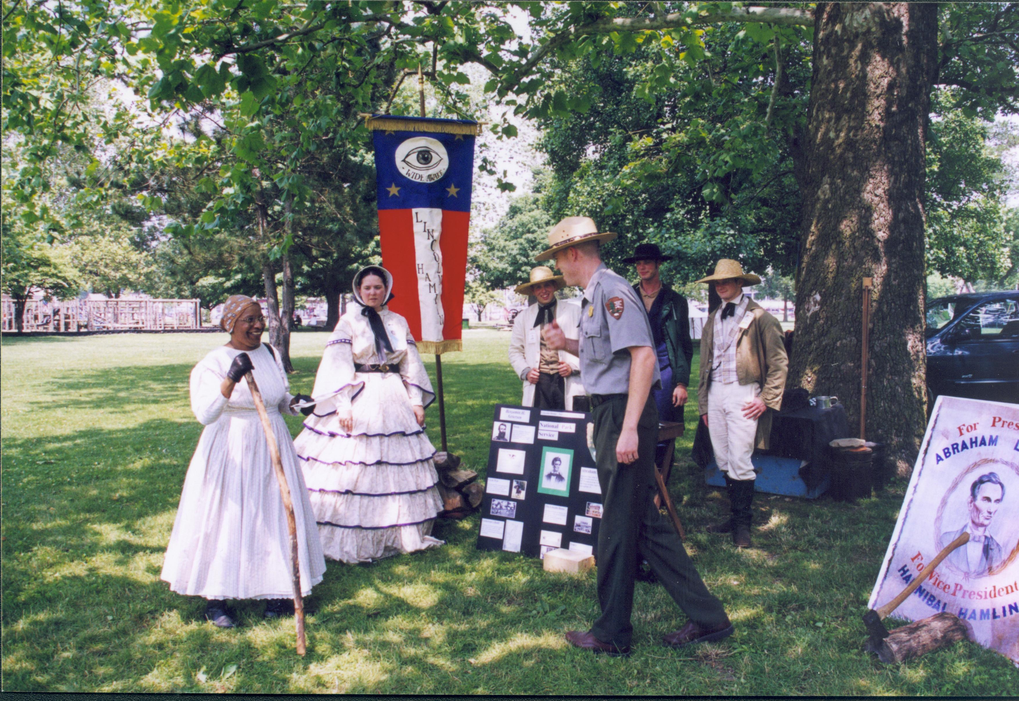 People in period dress in front of poster/pictures. Lincoln Home NHS- Grierson Days Jacksonville Grierson, Jacksonville, celebration