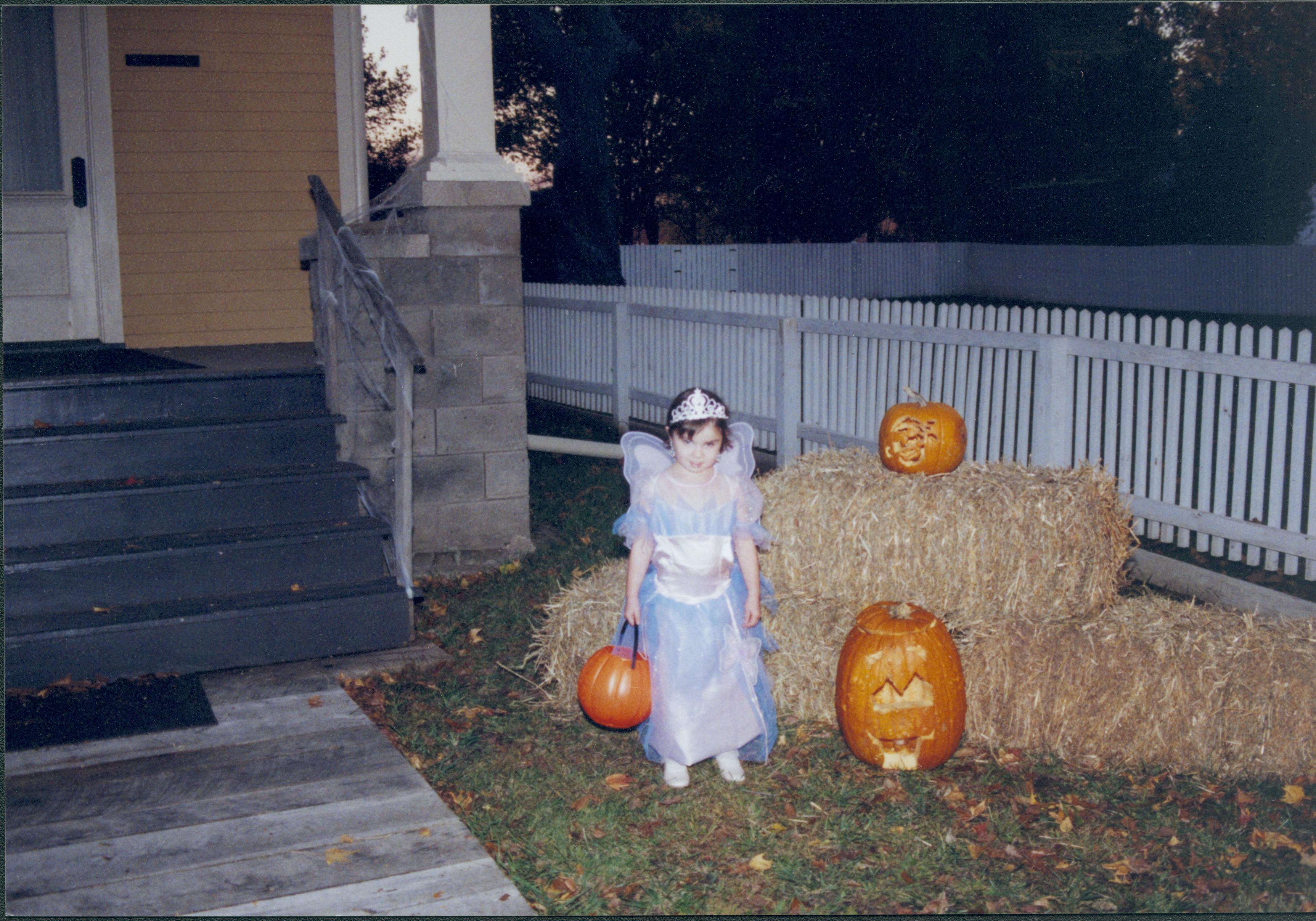 Little girl in costume in front of bales of straw. Lincoln Home NHS- Halloween halloween, costumes, decorations