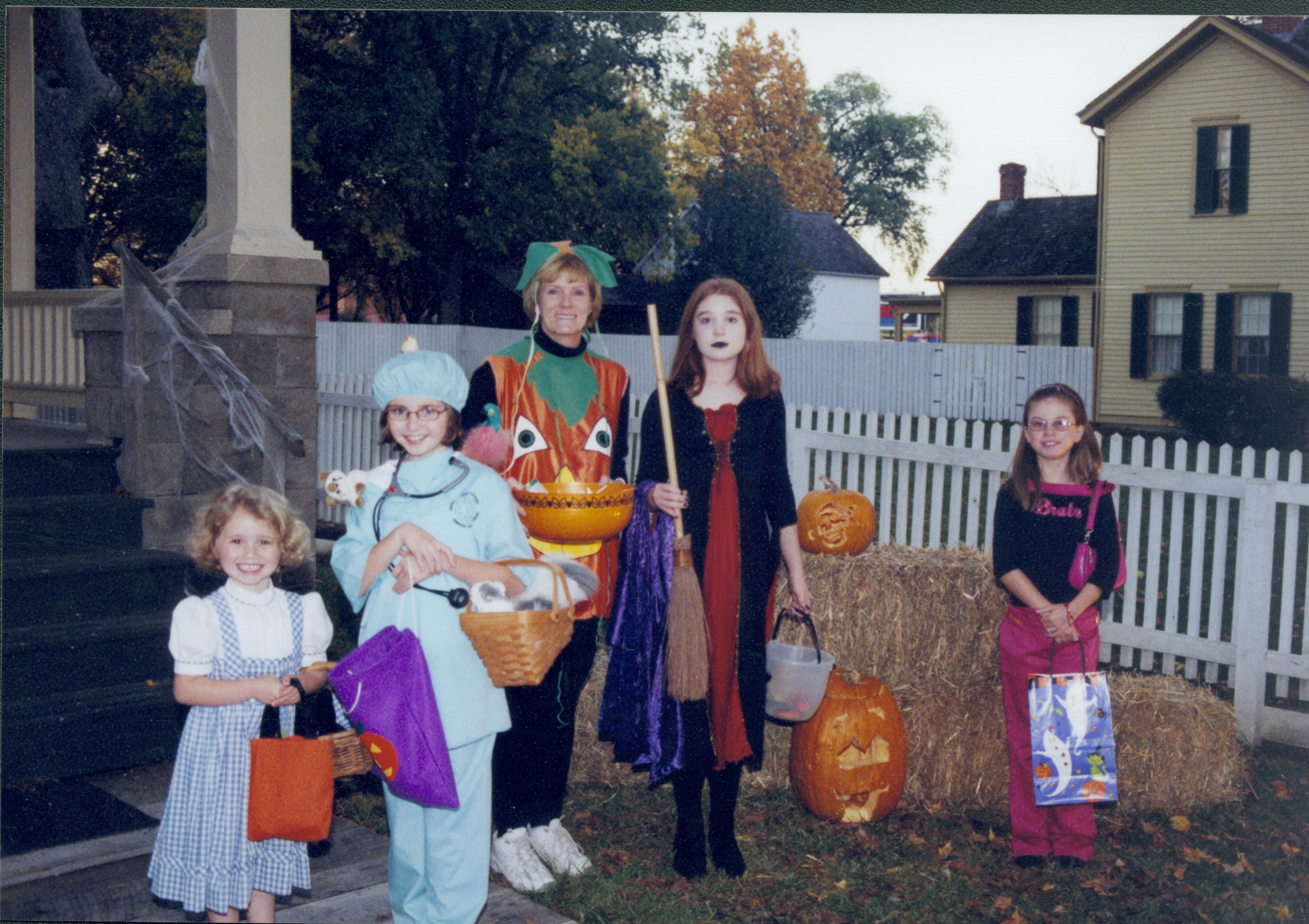 Five people in costume standing in front of straw bale. Lincoln Home NHS- Halloween halloween, costumes, decorations