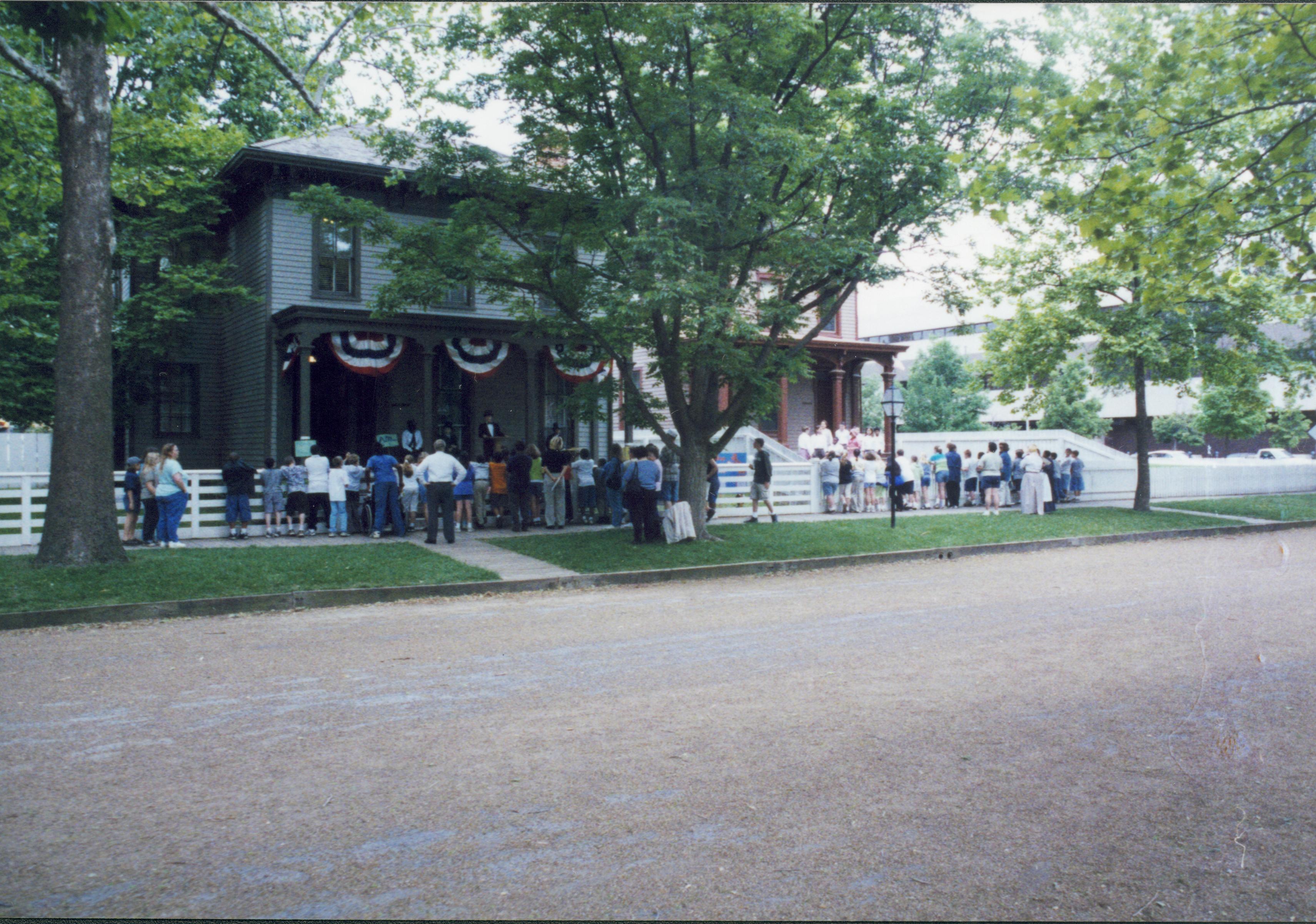 Iles School Living History program - Lincoln-Douglas debates performed by students on Lyon House. Education in the 1800s performed by students at the Beedle House on right.  School groups watch performances from 8th Street boardwalks.  Looking Northwest from 8th Street. Iles School, living history, Lincoln-Douglas debates, education, students, school groups