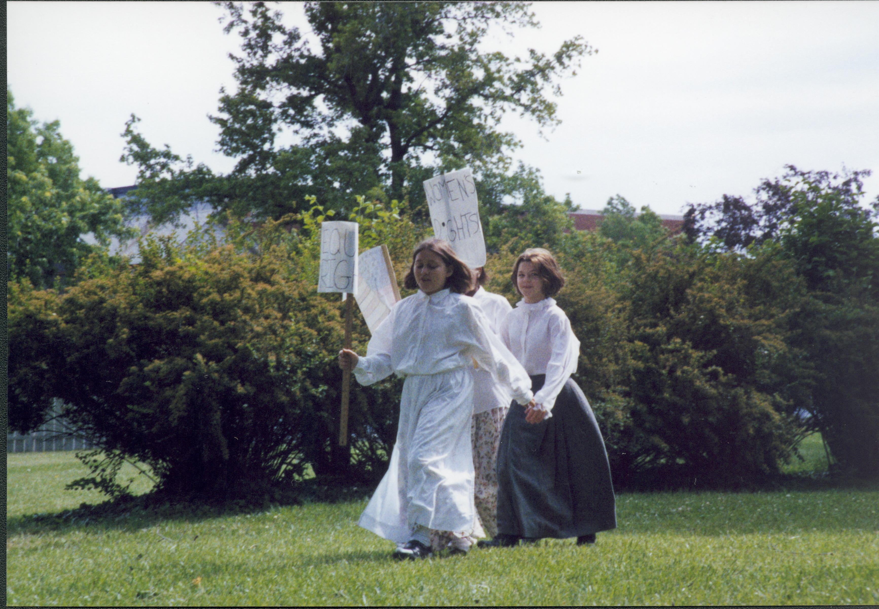 Iles School Living History program - students portraying Women's Rights suffragettes in the Carrigan lot (Block 10, Lot 6).  Looking Northeast from 8th Street (zoomed in) Iles School, living history, students, Carrigan, Women's Rights