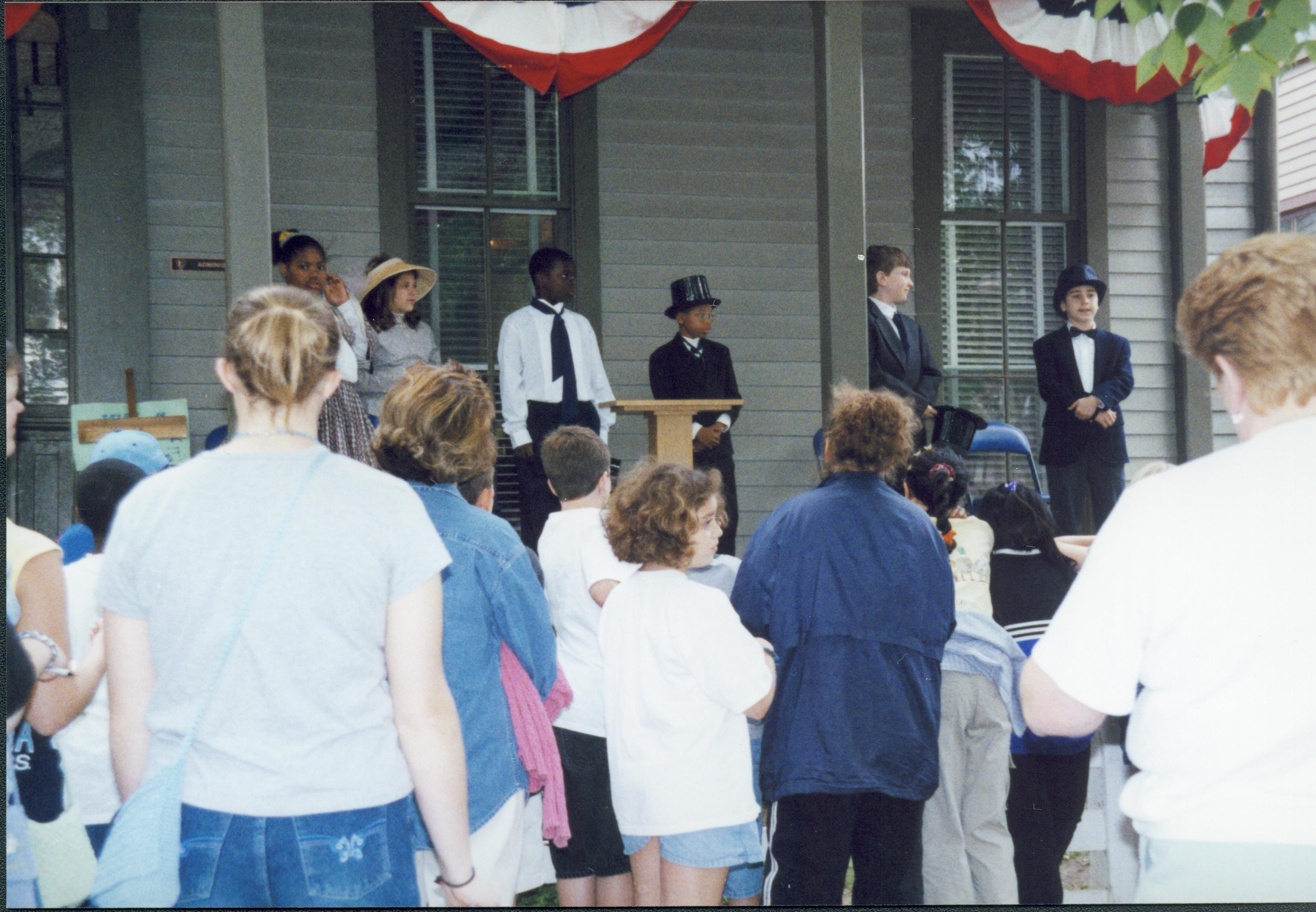 Iles School Living History program - Students portraying the Lincoln-Douglas debates on the Lyon House porch while school groups and parents watch. Looking West from 8th Street Iles School, living history, Lincoln-Douglas debates, students, school groups, Lyon