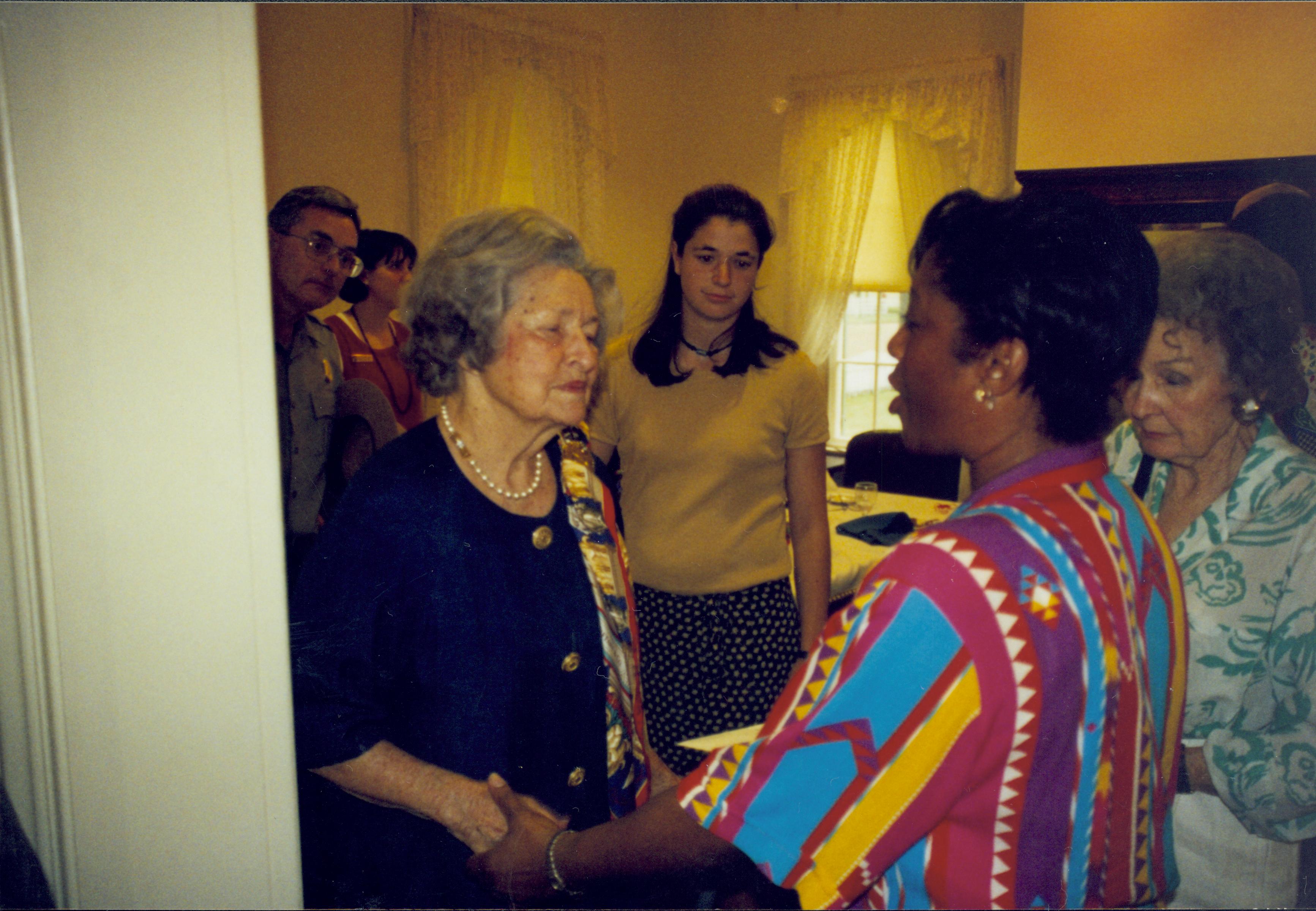 Lady talking to African American in colorful blouse. Lincoln Home NHS- Lady Bird Johnson visit, roll #2 neg #1 Johnson, visit, tour