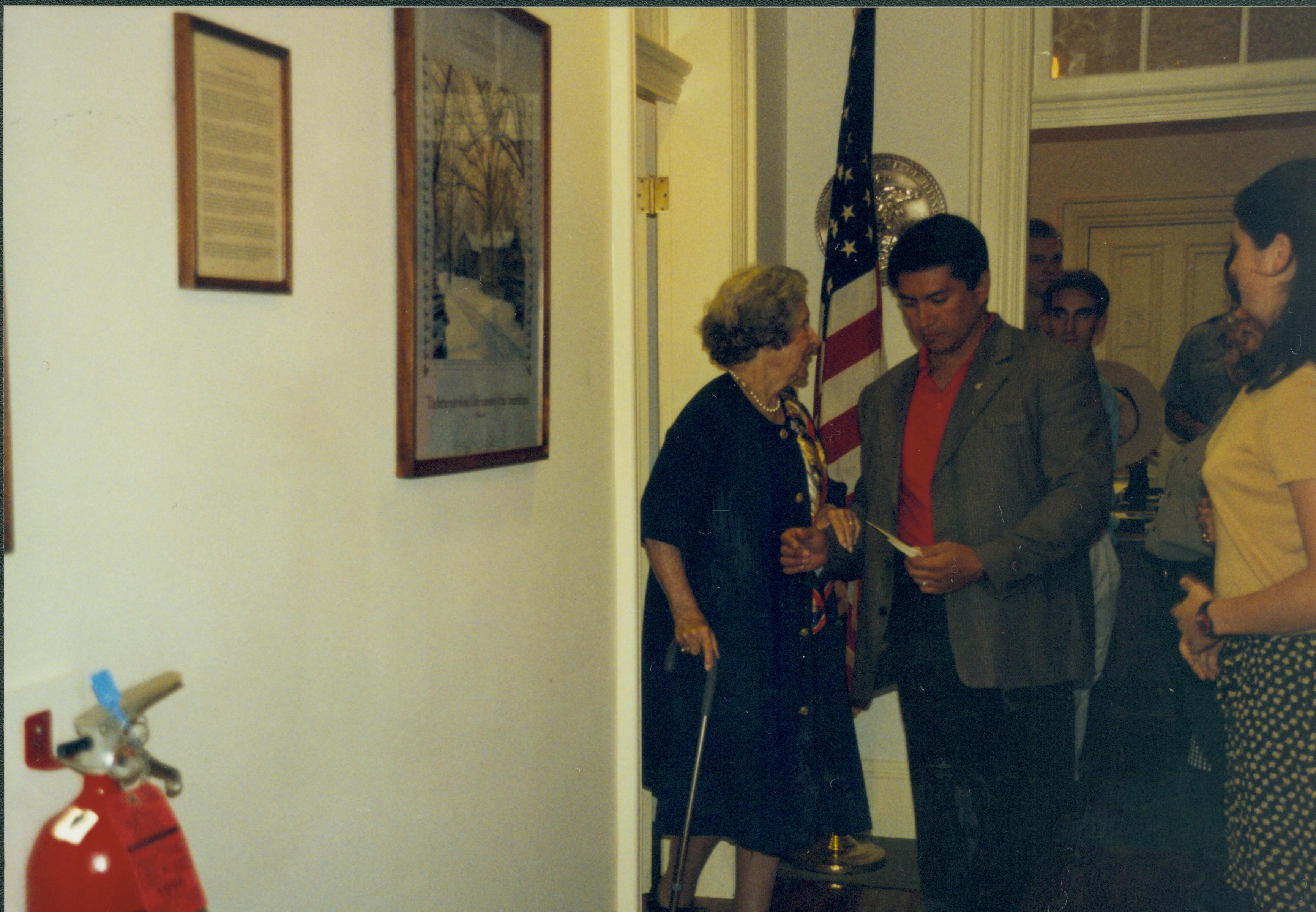 Two people standing in door way, American flag behind them. Lincoln Home NHS- Lady Bird Johnson visit, roll #2 neg #4 Johnson, visit, tour