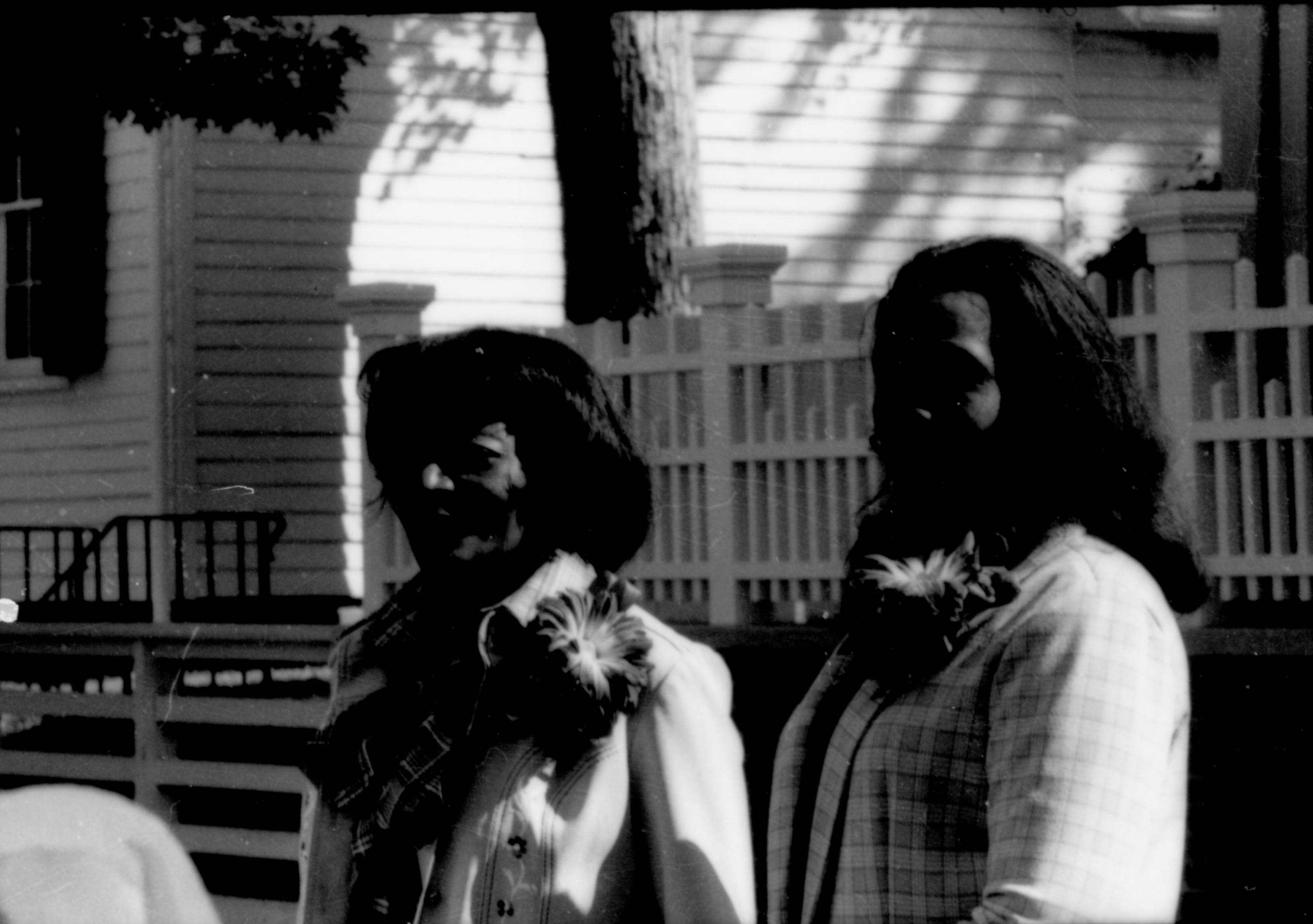 Two ladies standing by Lincoln fence. Lincoln Home NHS- Coretta King Visit King, visit