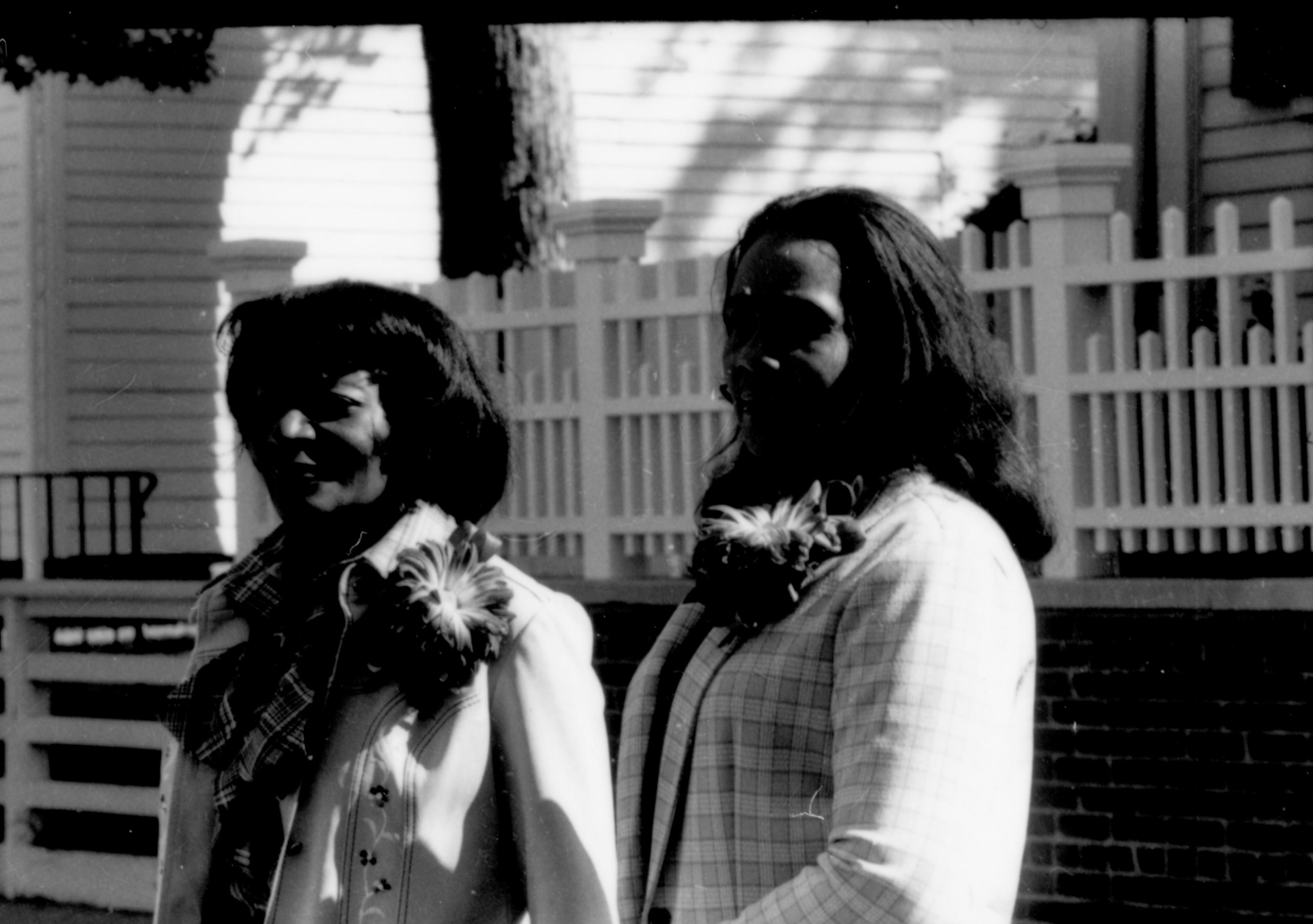 Two ladies standing by Lincoln fence. Lincoln Home NHS- Coretta King Visit King, visit