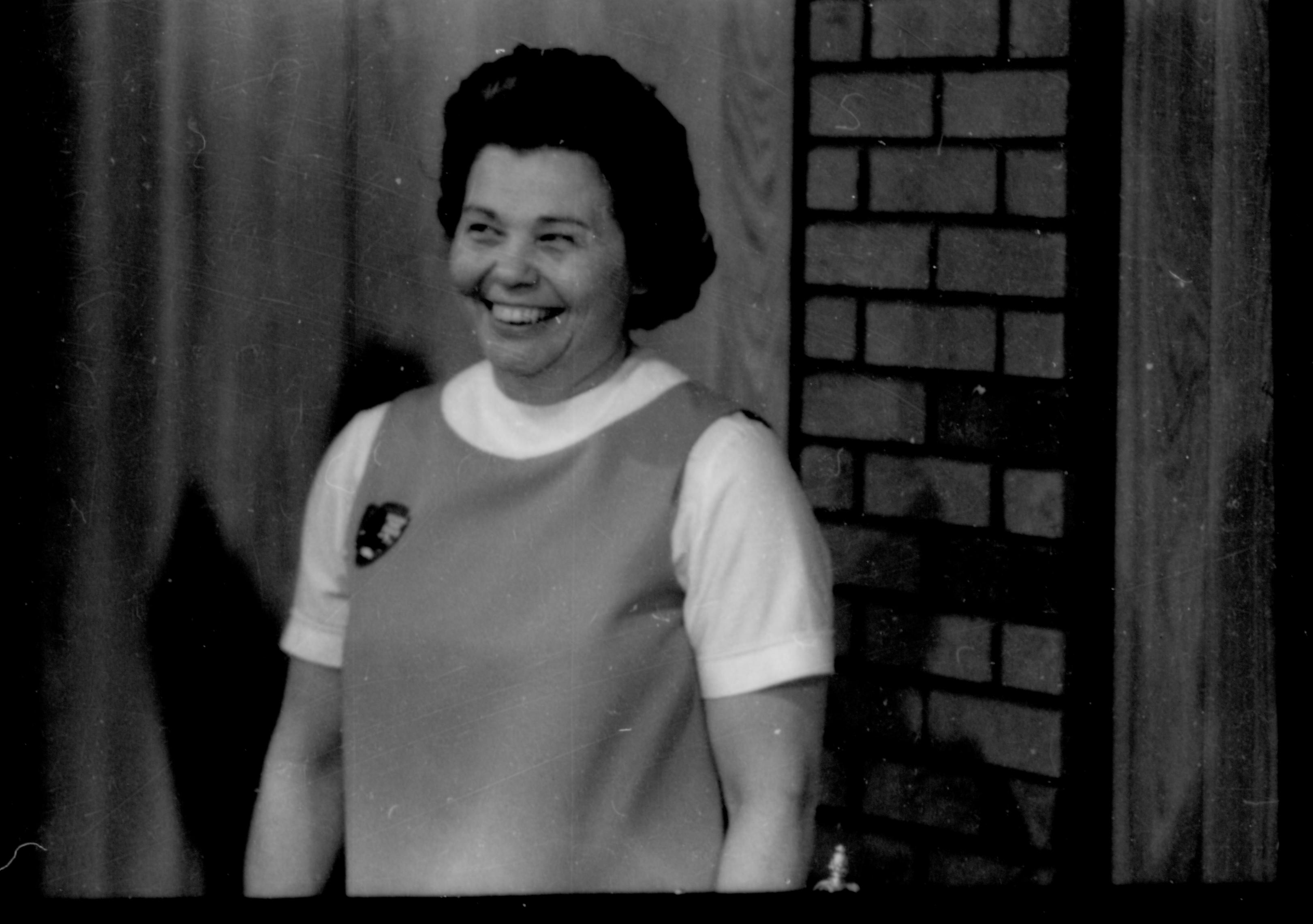 Lady smiling in front of brick background. Lincoln Home NHS- Coretta King Visit King, visit, tour