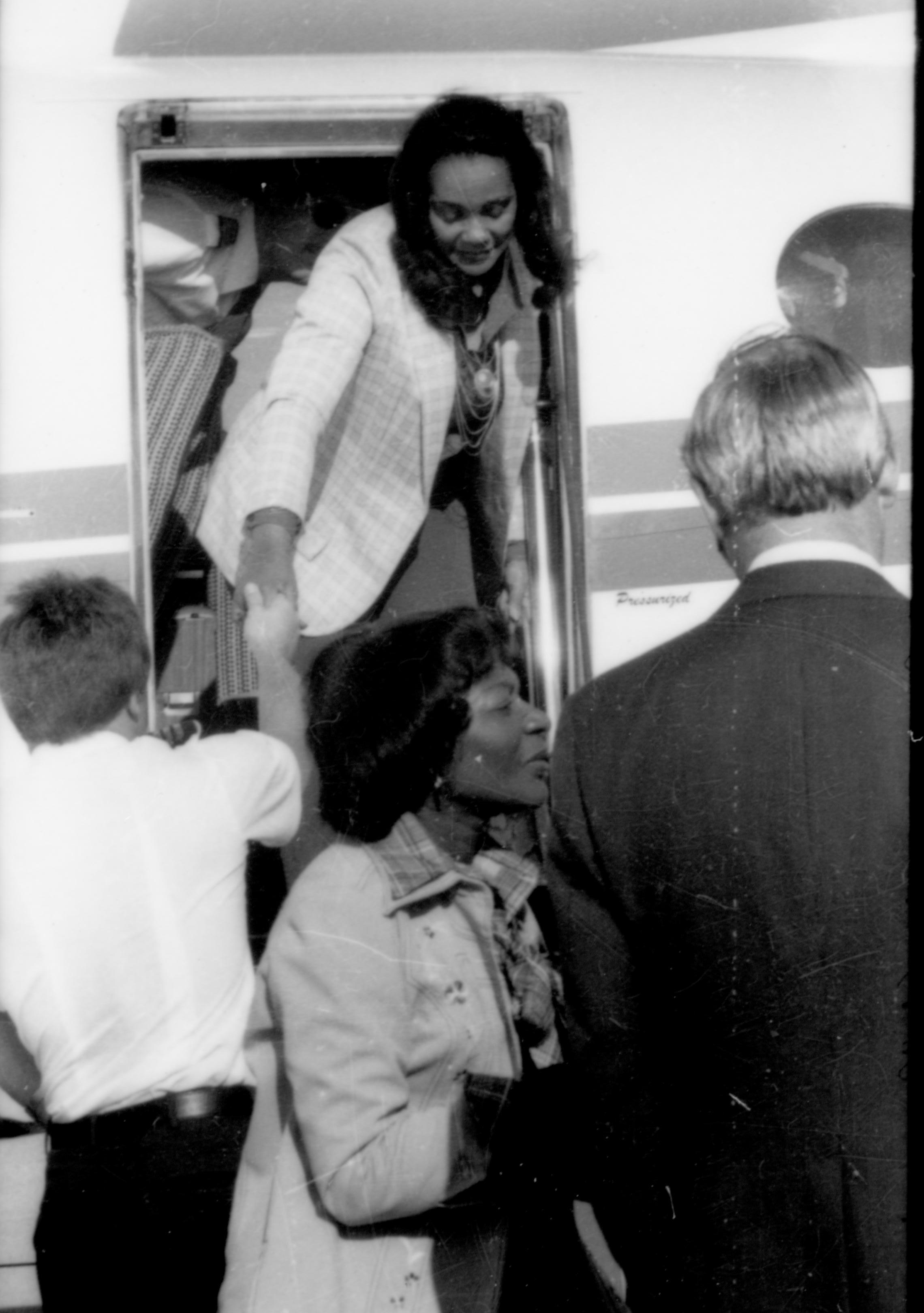 Lady getting off plane. Lincoln Home NHS- Coretta King Visit King, visit, airport