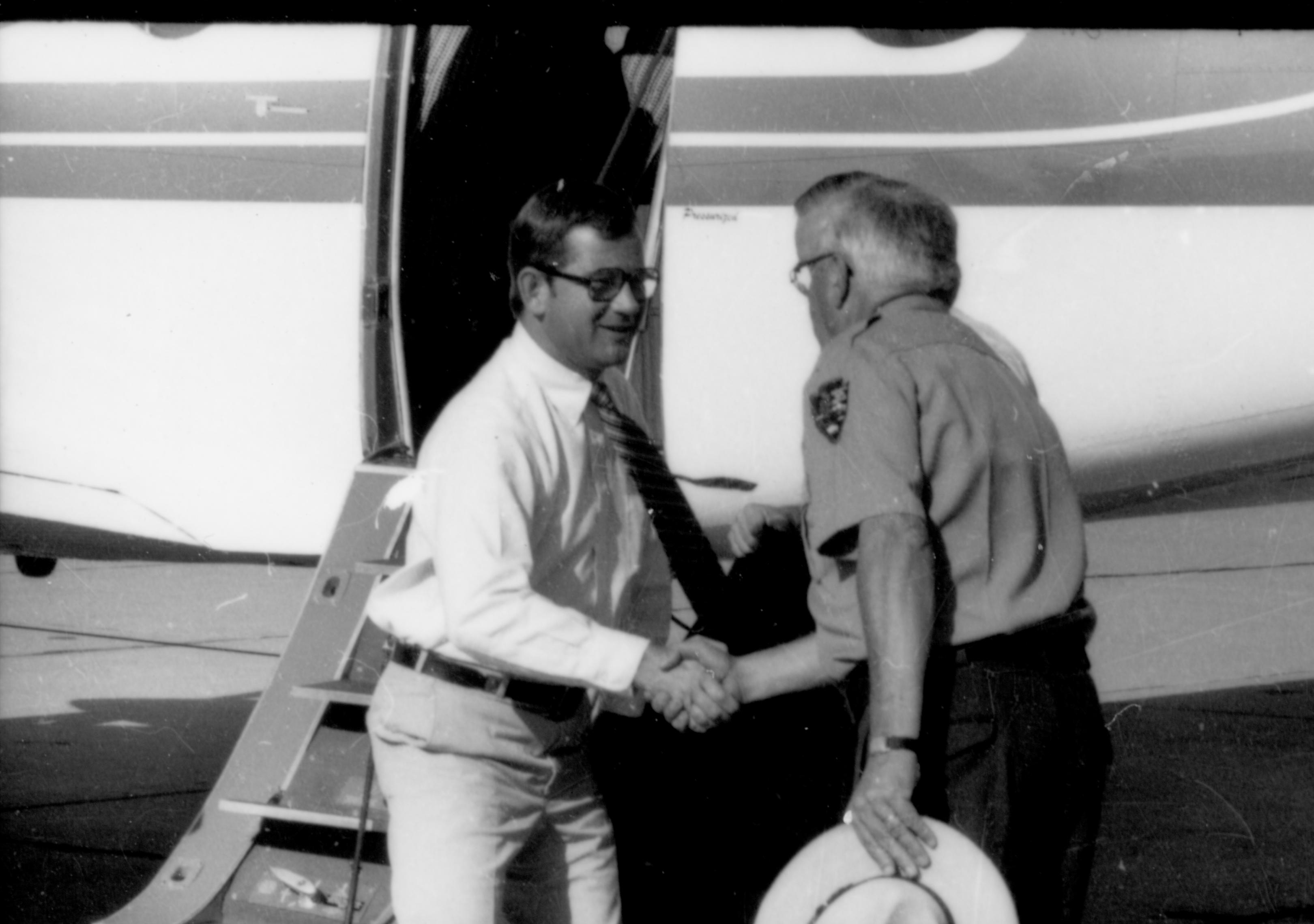 Ranger shaking hands with man at plane. Lincoln Home NHS- Coretta King Visit King, visit, airport