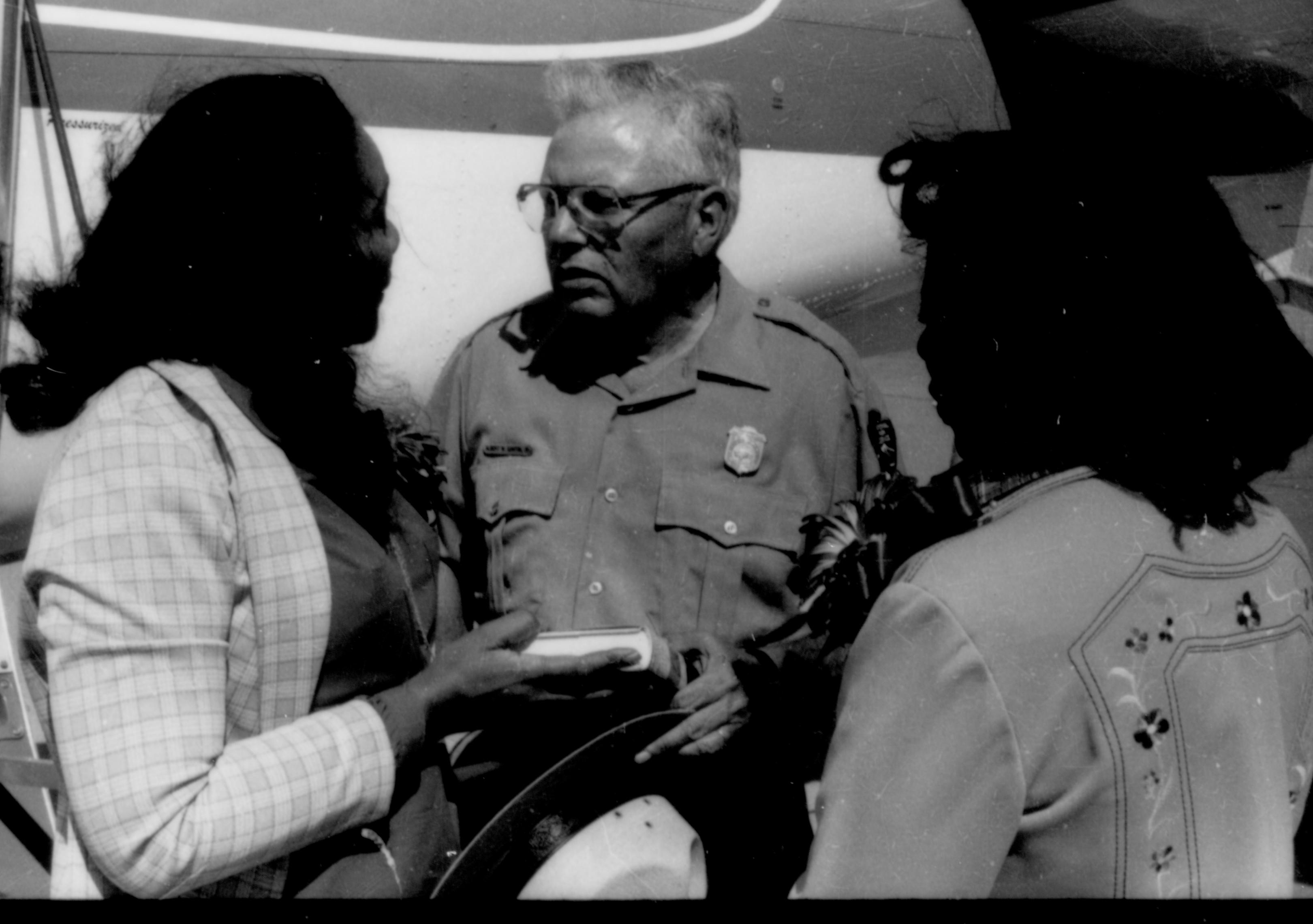 Ranger talking to two ladies, presenting book. Lincoln Home NHS- Coretta King Visit King, visit, tour