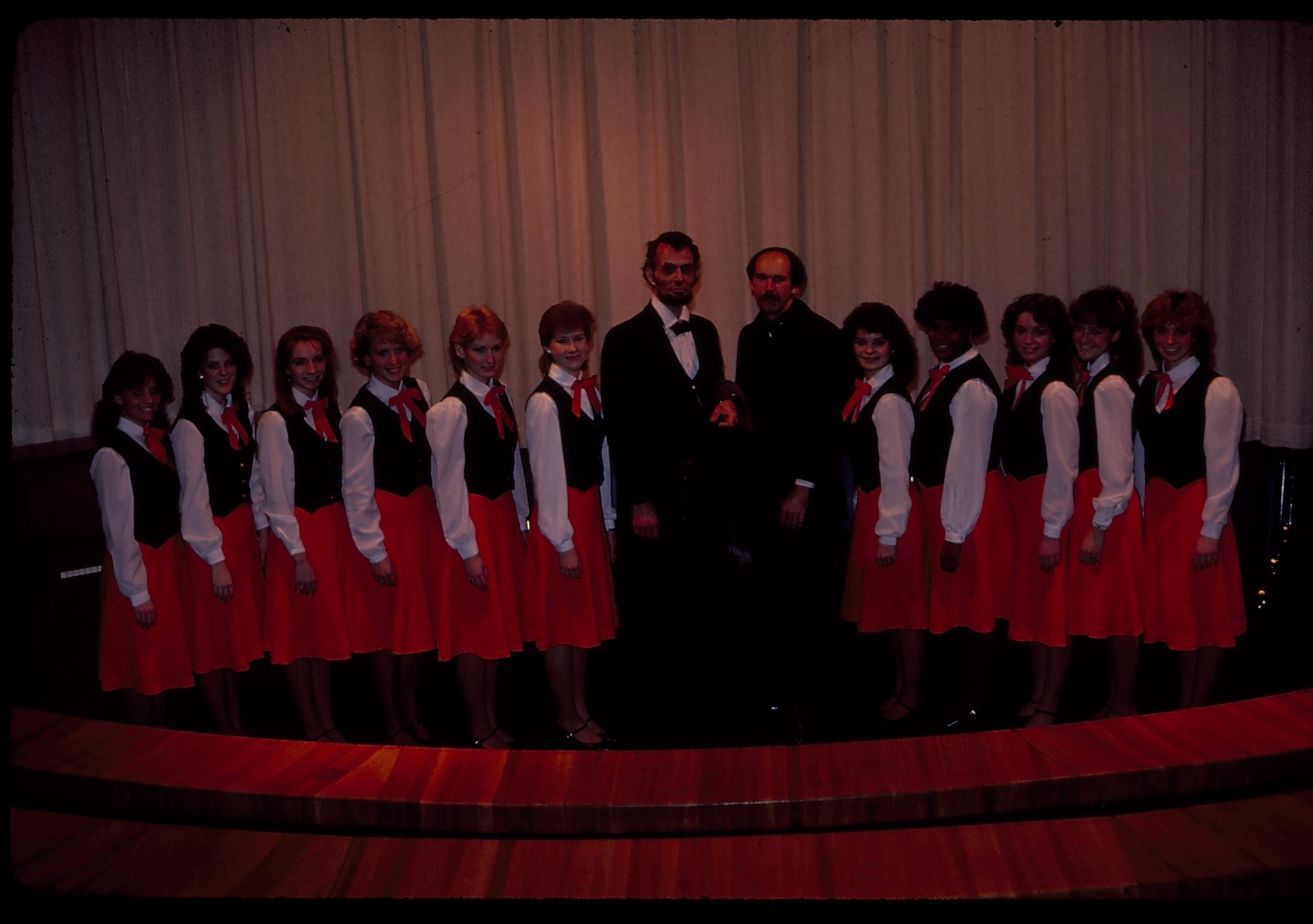 Womans choral group in theater one with impersonators. Lincoln Home NHS- Lincoln's Birthday 1984 birthday, Lincoln