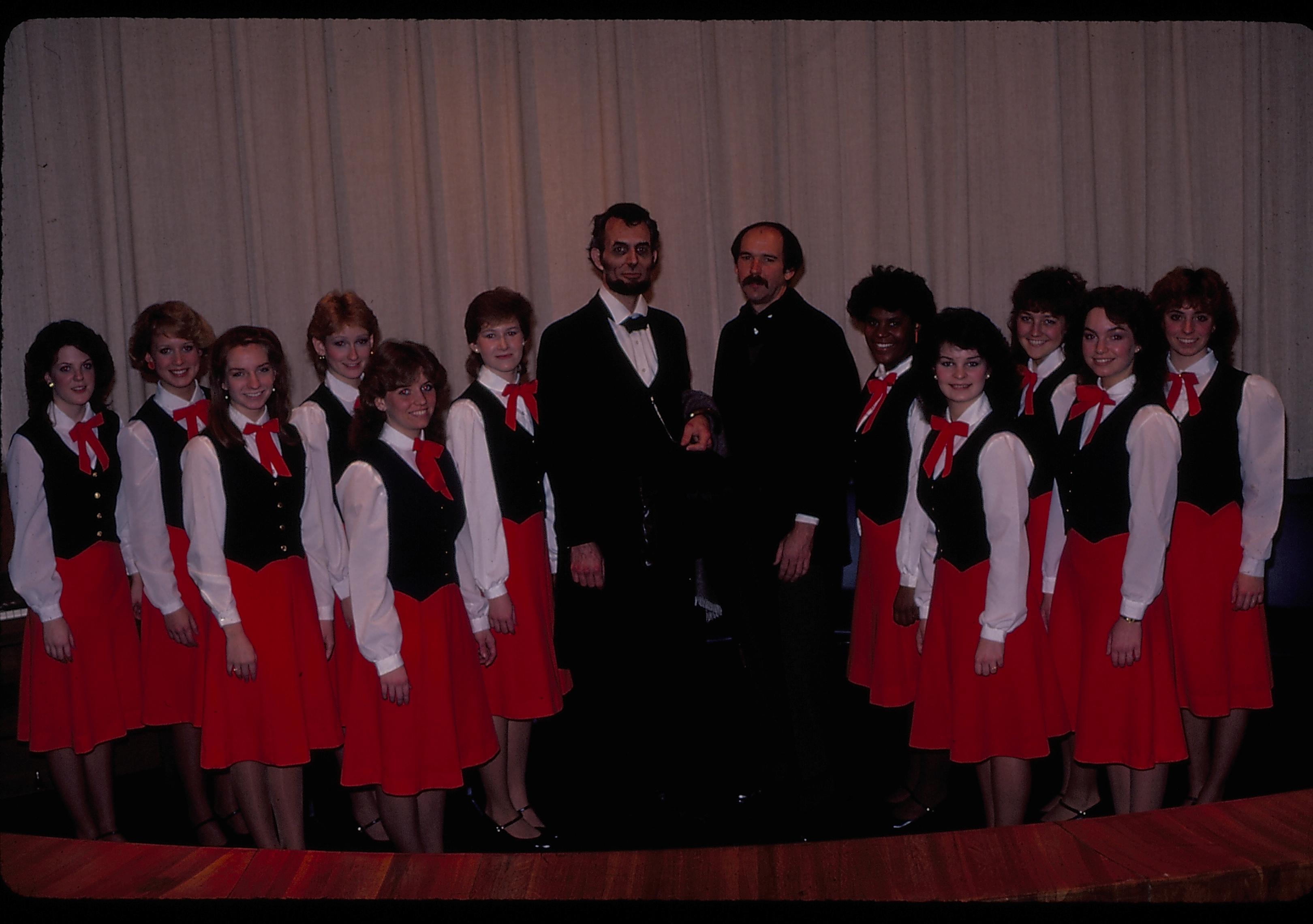 Womans choral group in theater one with impersonators. Lincoln Home NHS- Lincoln's Birthday 1984 birthday, Lincoln