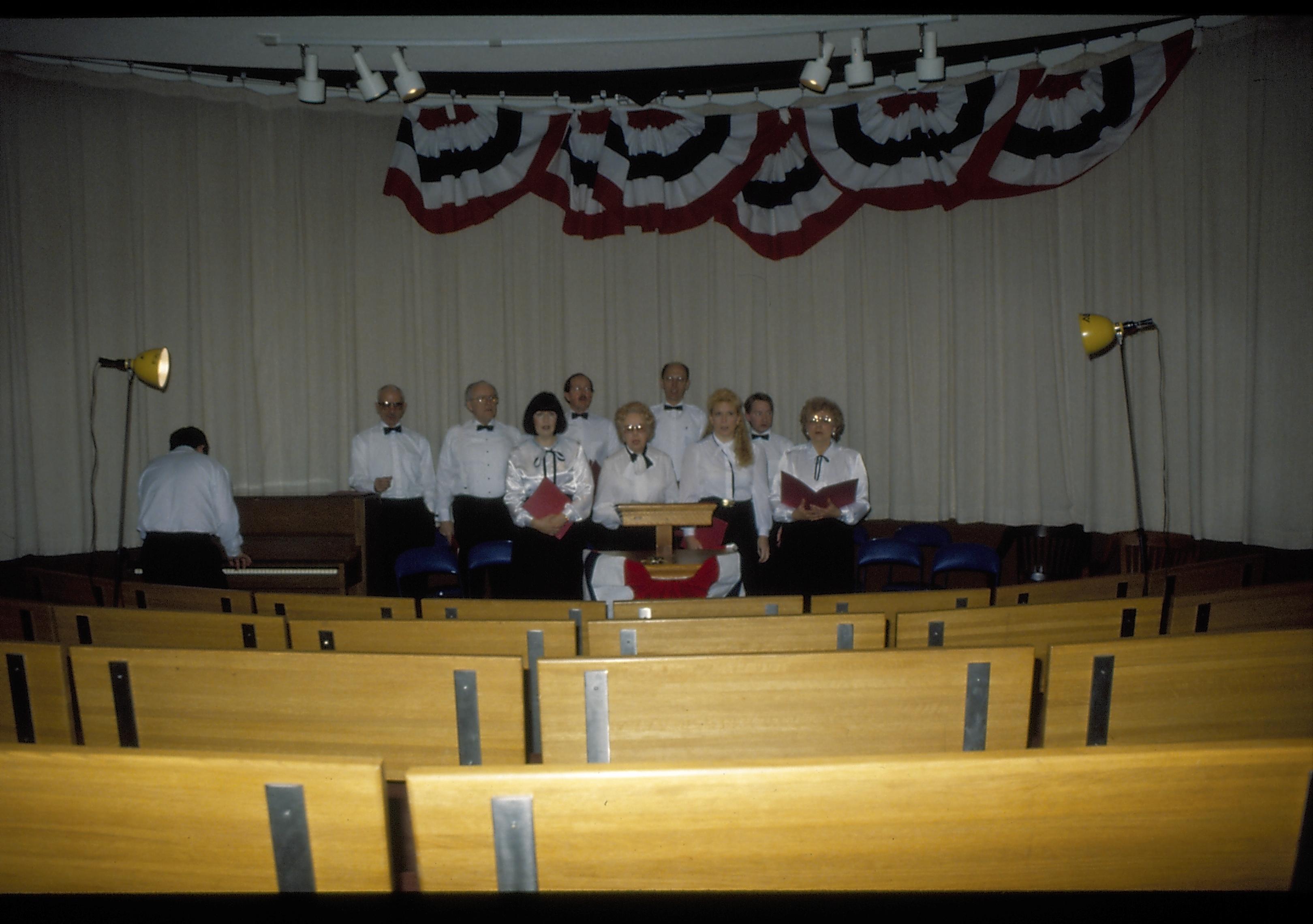 Choir standing in front of curtain in theater one. Lincoln Home NHS- Lincoln's Birthday 1988 birthday, Lincoln, Douglas, musical