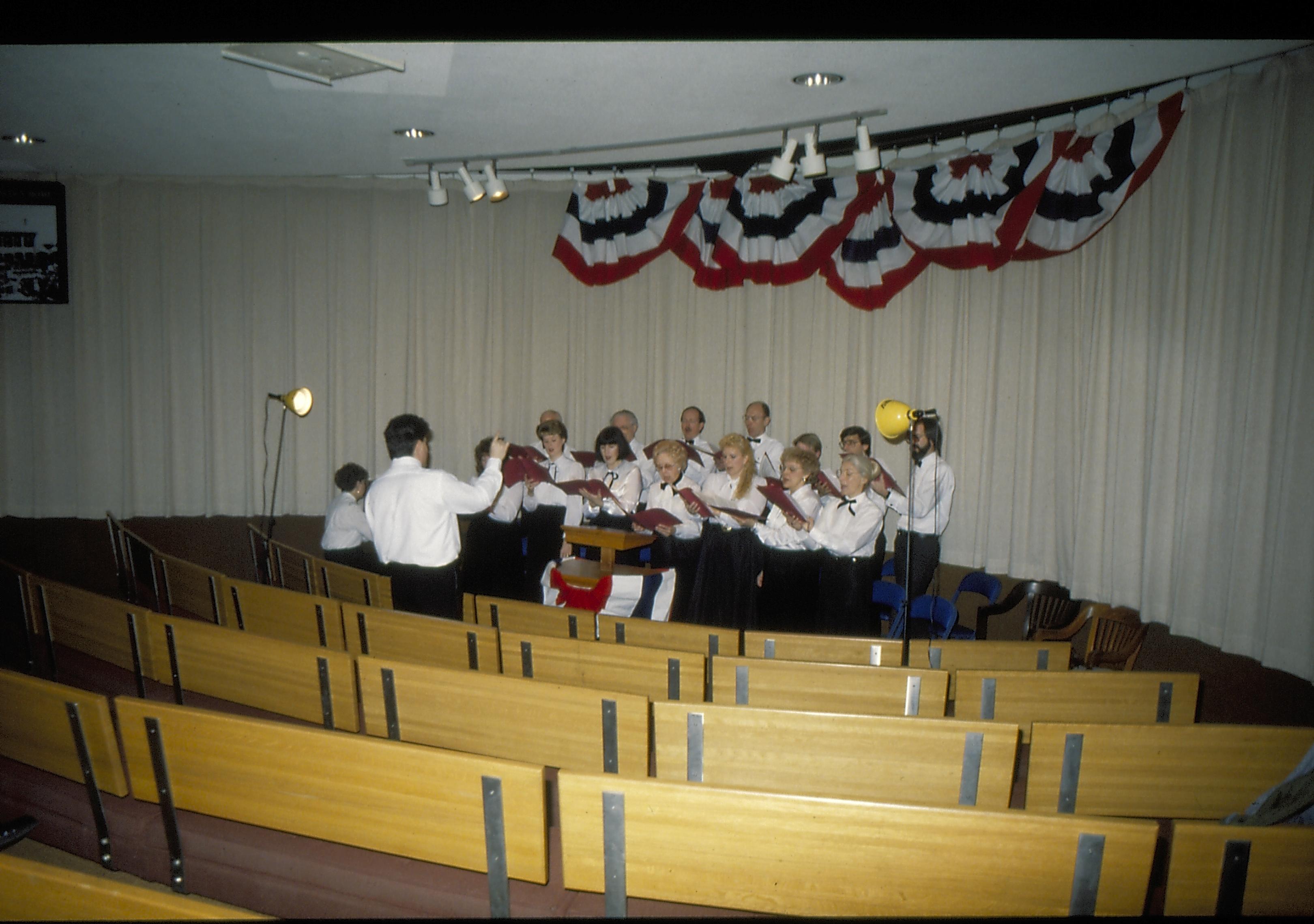 Choir rehearsing in theater one. Lincoln Home NHS- Lincoln's Birthday 1988 birthday, Lincoln, Douglas, musical