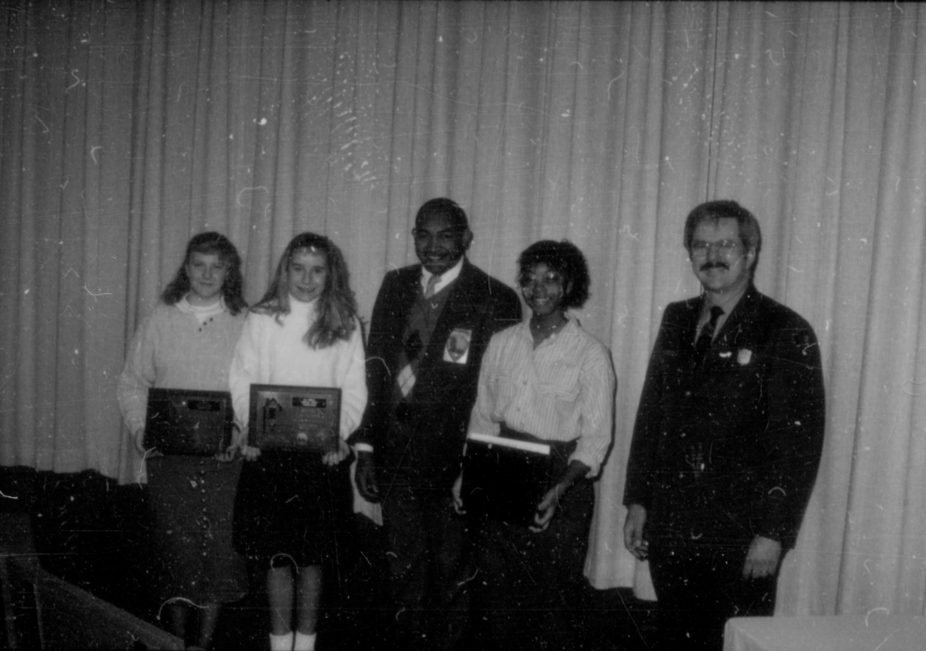 Three young ladies (with awards) and two men in front of curtain. Lincoln Home NHS- Lincoln's Birthday 1988, 26 birthday, Lincoln, award