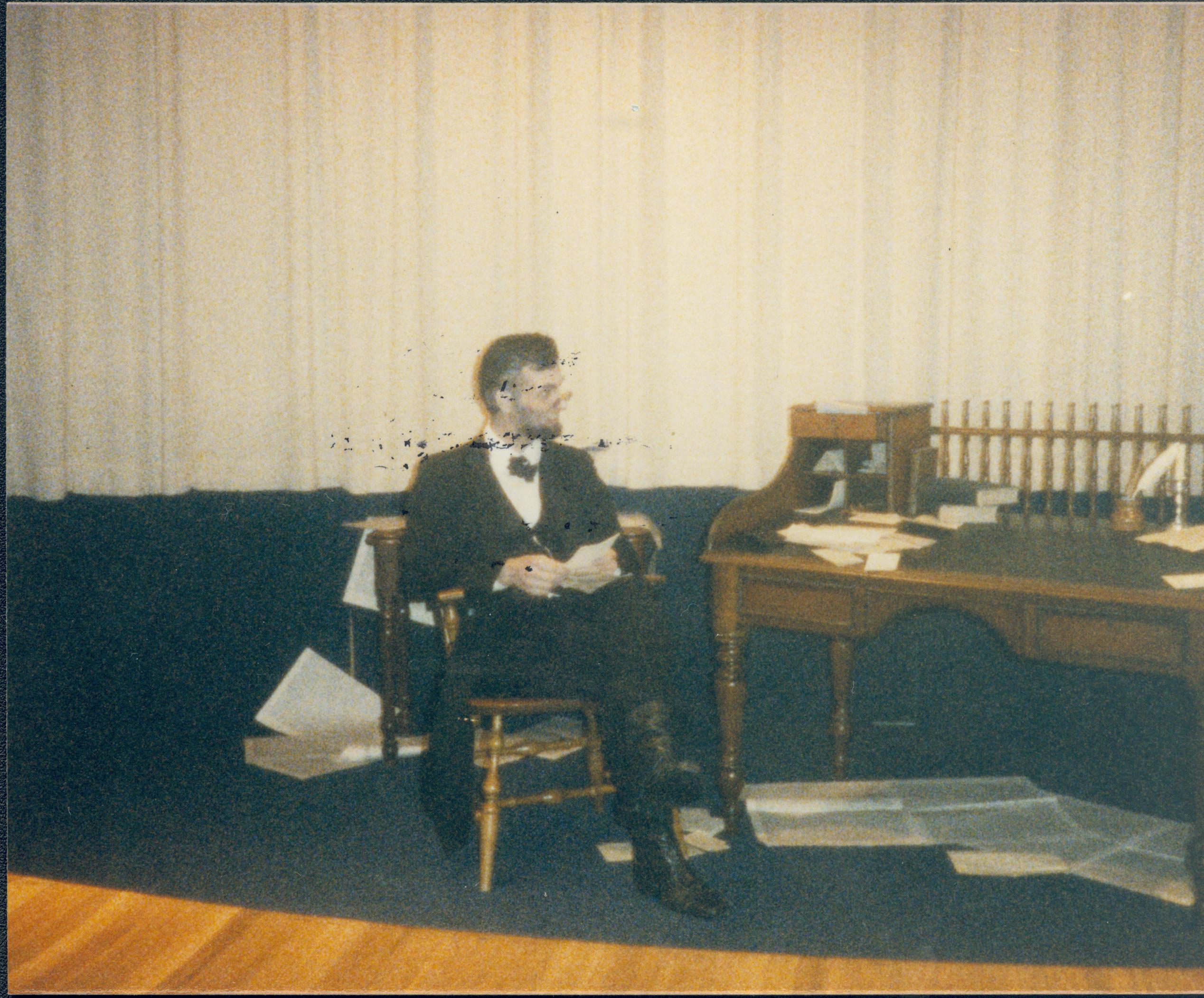 Lincoln impersonator sitting beside desk. Lincoln Home NHS- Lincoln's Birthday birthday, Lincoln, play