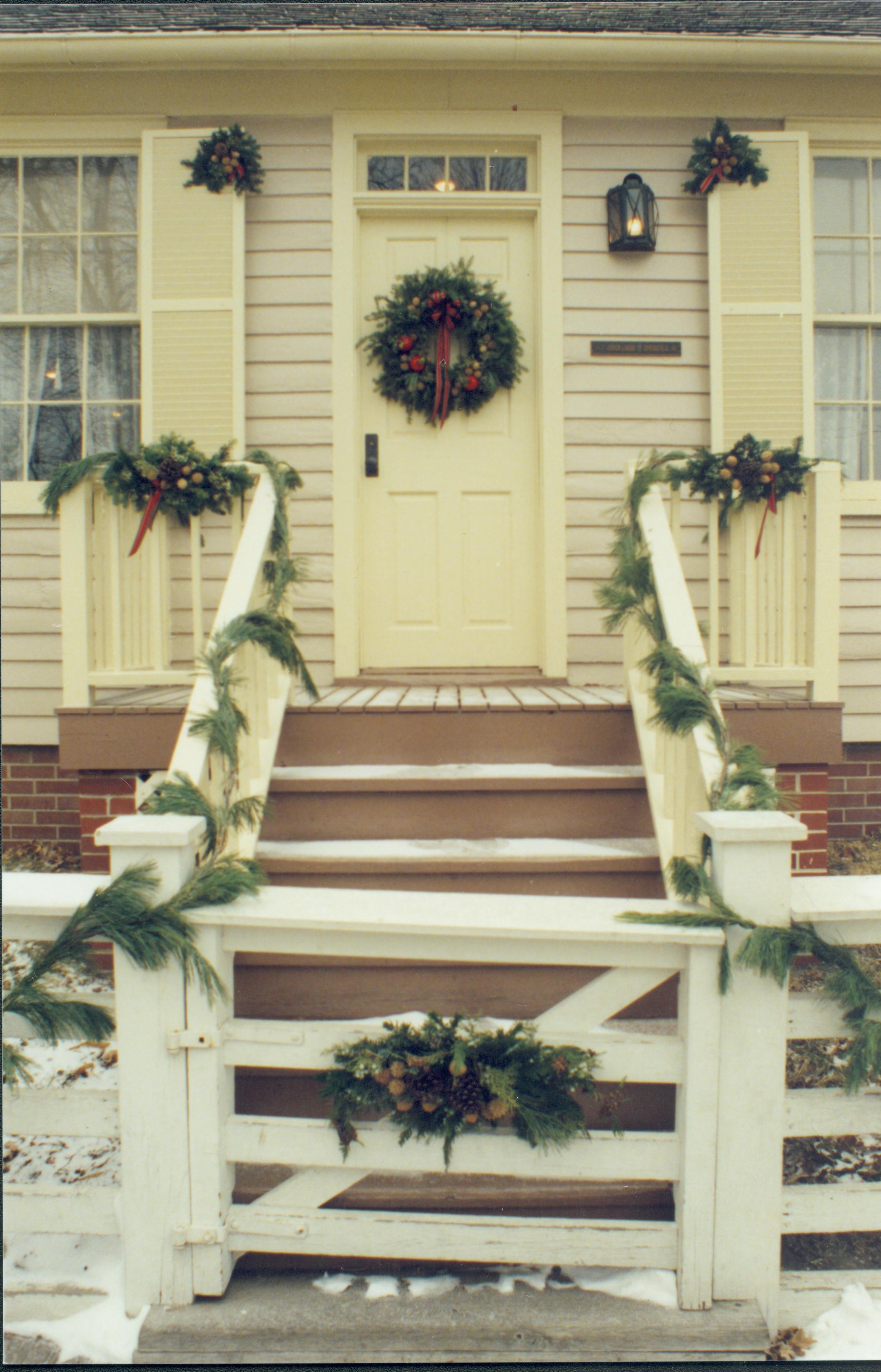 Lincoln Home NHS- Christmas in Lincoln Neighborhood Looking east, Christmas decor on porch and fence of Corneau house. Christmas, neighborhood, Corneau, porch, wreath, garland, decor