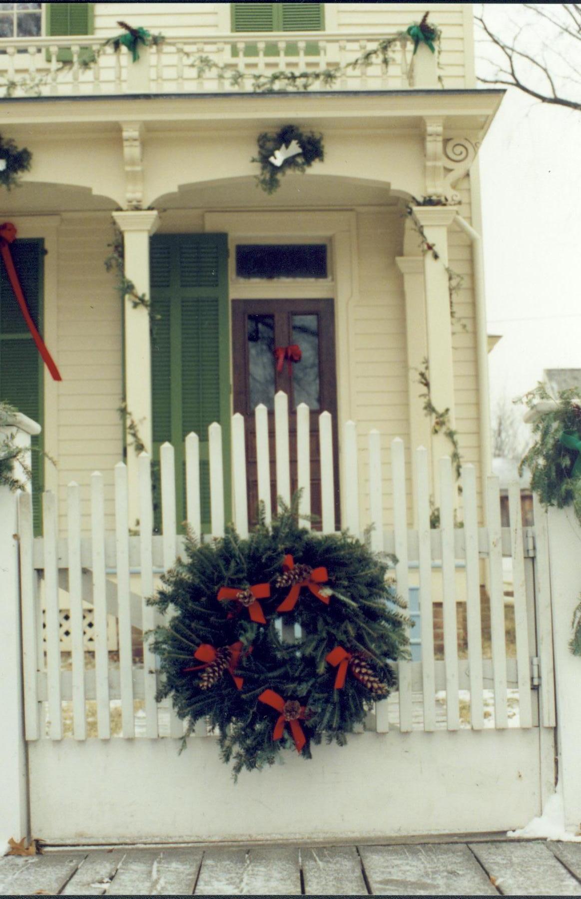 Lincoln Home NHS- Christmas in Lincoln Neighborhood Looking east, Christmas decor on fence and porch of Robinson house. Detail. Christmas, neighborhood, Robinson, wreath, garland, decor, detail, fence