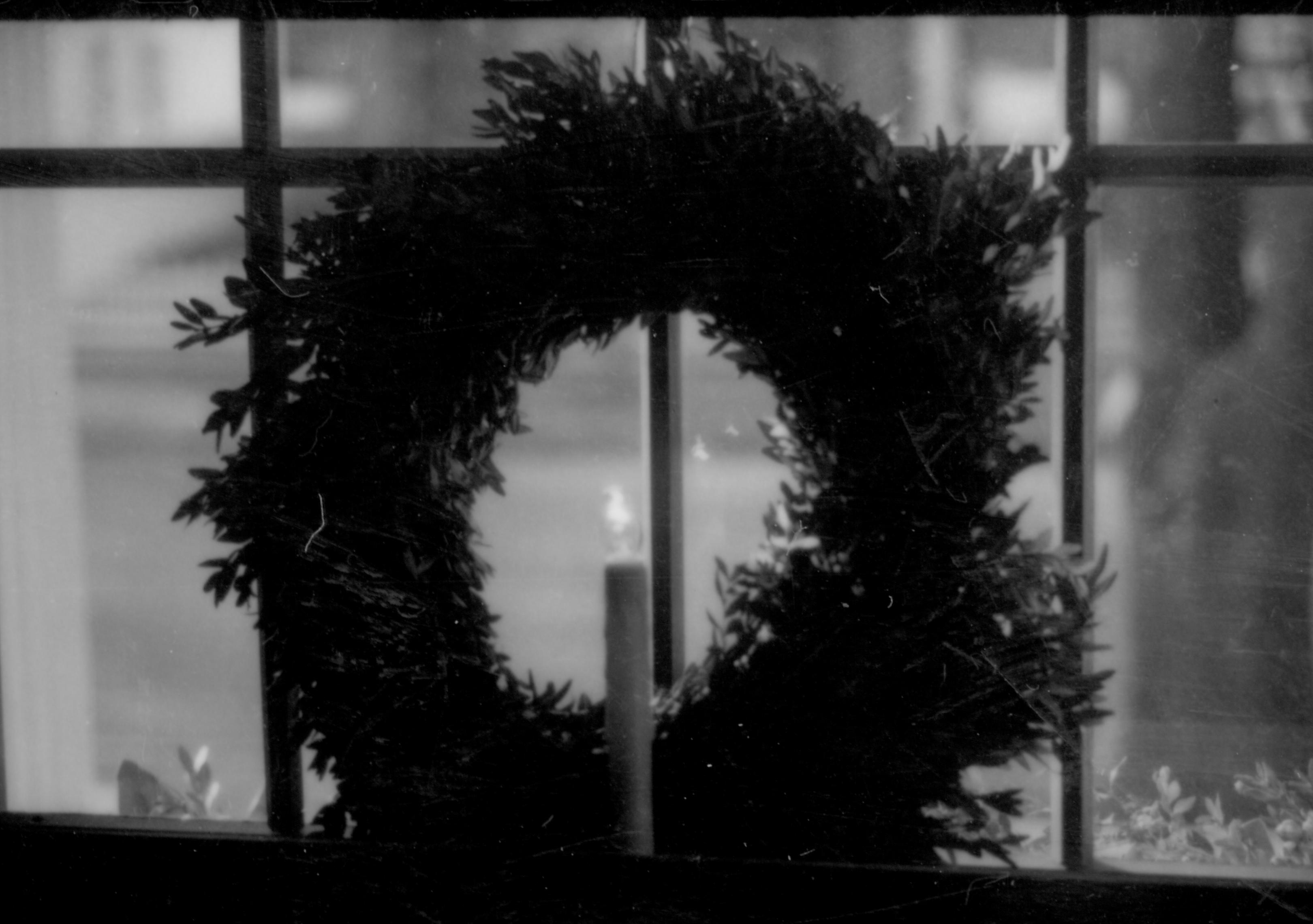 Lincoln Home NHS- Christmas in Lincoln Neighborhood Christmas decor on interior window sill. Christmas, neighborhood, wreath, candle, electric