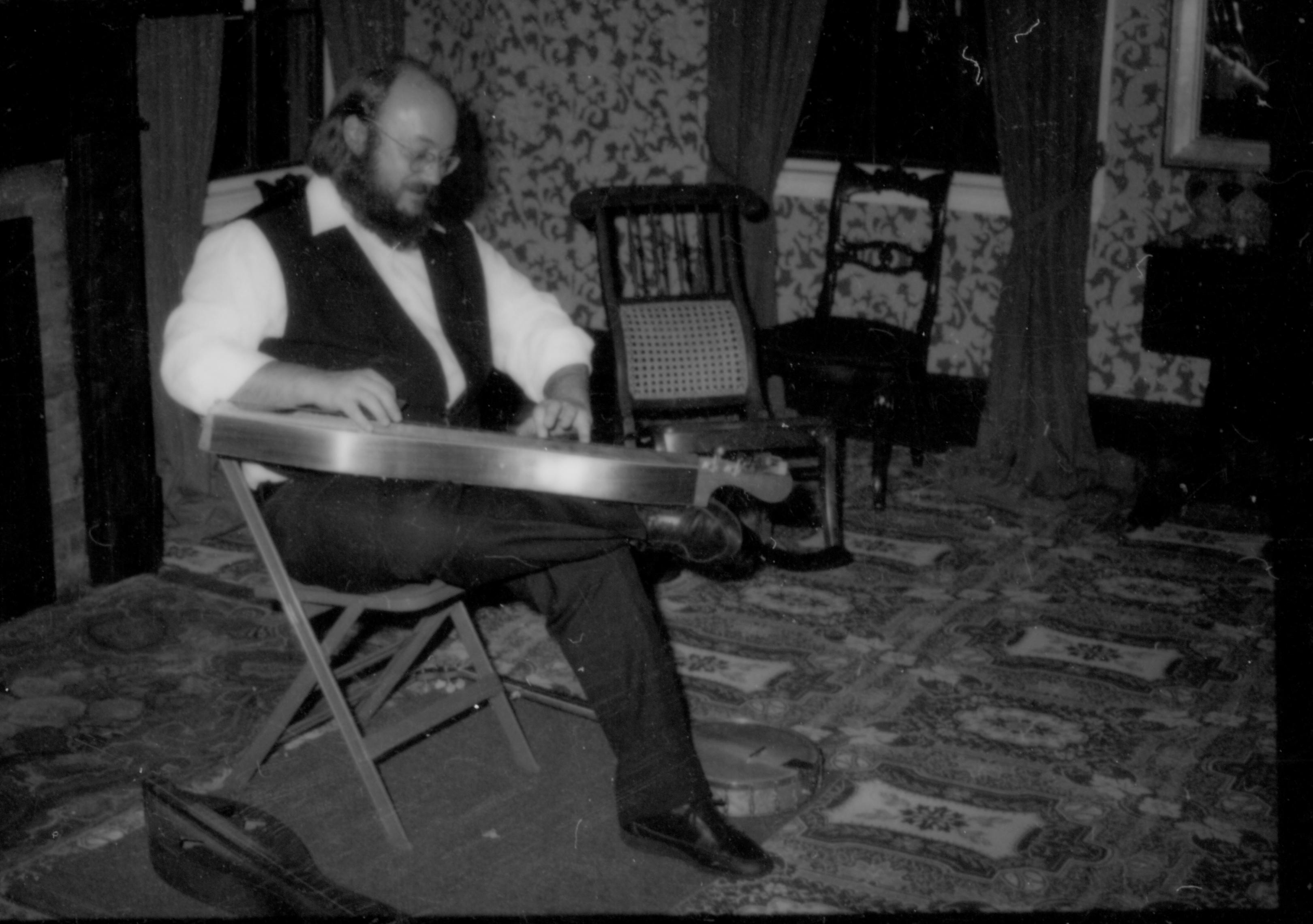 Lincoln Home NHS- Christmas in Lincoln Neighborhood Looking south west, entertainer playing instrument in Lincoln Home Sitting room. exhibit, musician, Lincoln, home, Sitting, room. event