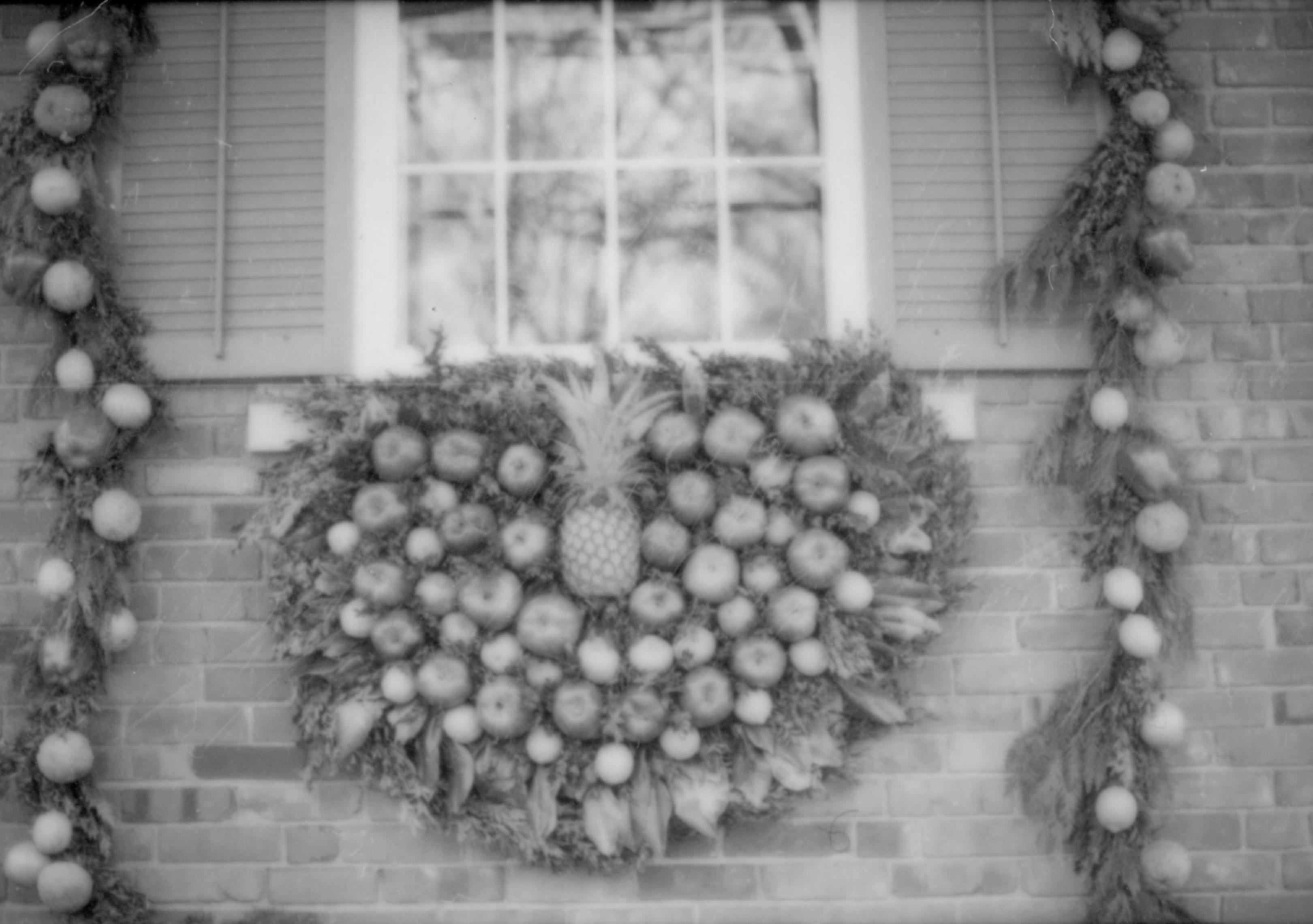 Lincoln Home NHS- Christmas in Lincoln Neighborhood Wreath and garland on window and surround of Conference Cneter. Christmas, decorations, pineapple, decor, wreath, garland, conference, center