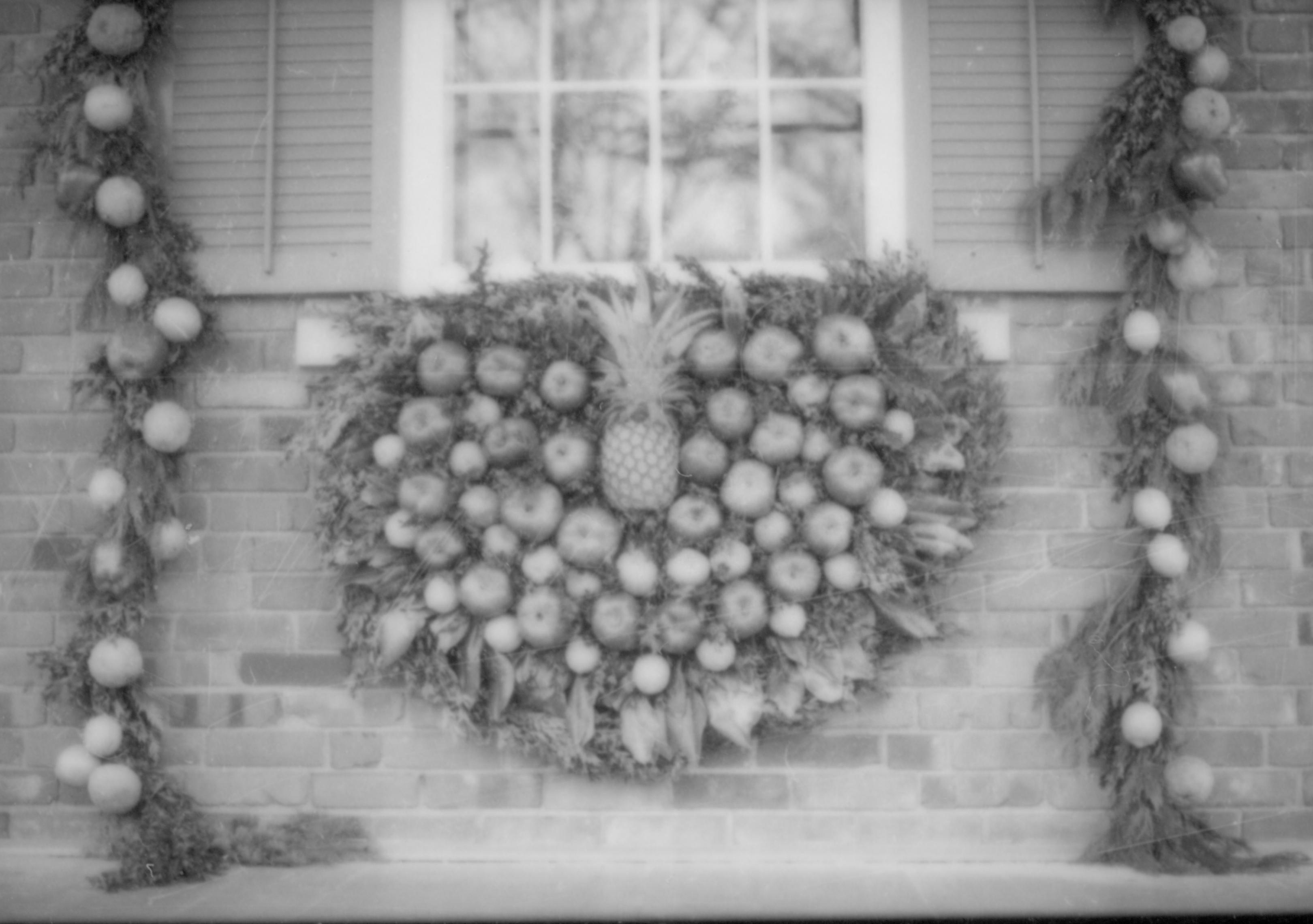 Lincoln Home NHS- Christmas in Lincoln Neighborhood Christmas decor on window and surround of Conference Center. Christmas, decorations, pineapple, wreath, garland, conference, center