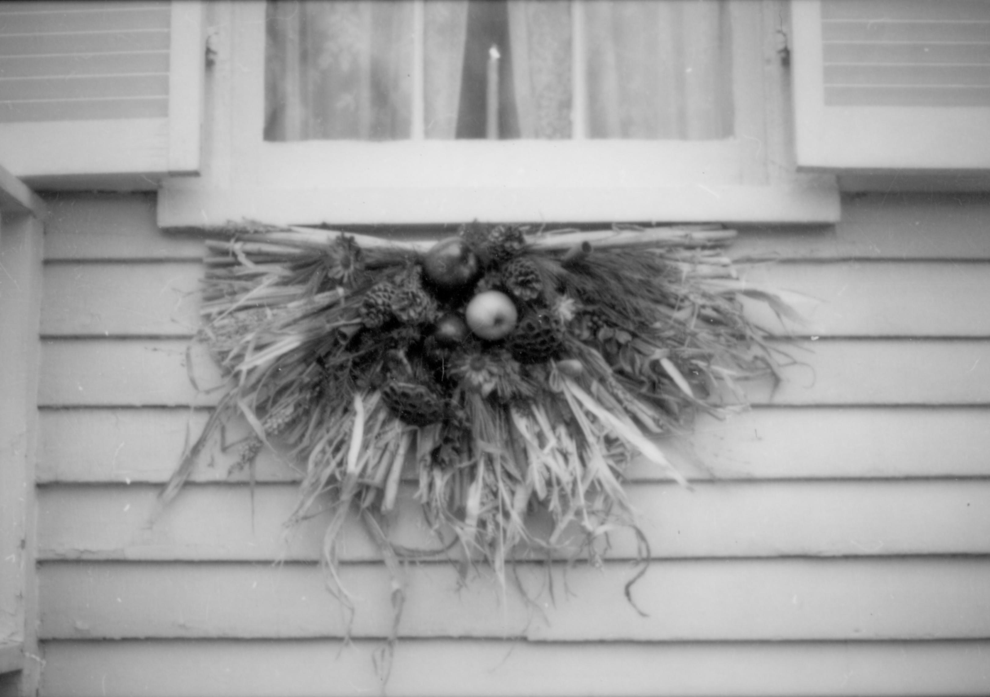 Lincoln Home NHS- Christmas in Lincoln Neighborhood Looking east, Christmas decor on window sill of Corneau (?) house. Detail. Christmas, decorations, neighborhood, Corneau, wreath, detail