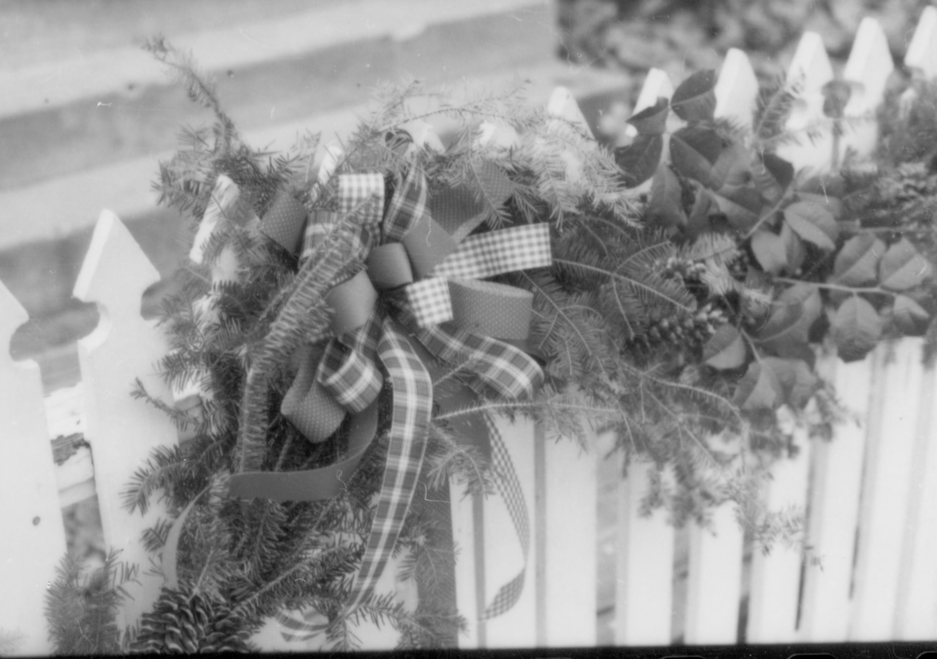 Lincoln Home NHS- Christmas in Lincoln Neighborhood Looking south east, Christmas garland on Corneau house fence. Detail. Christmas, decorations, neighborhood, garland, decor, fence