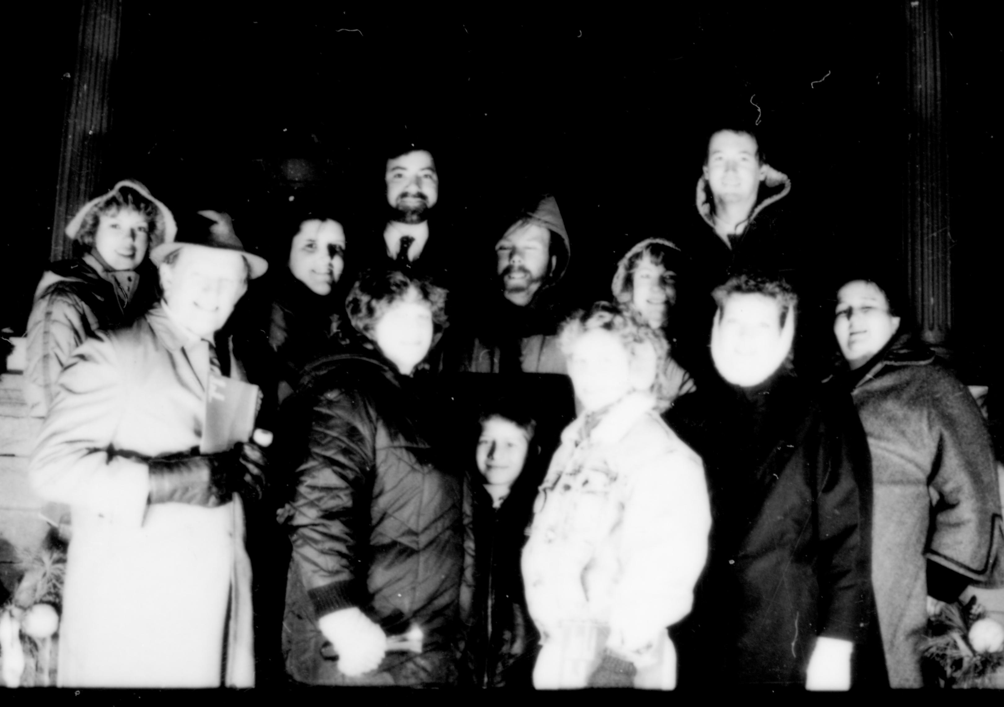 Lincoln Home NHS- Christmas in Lincoln Neighborhood  Visitors gathered on porch for photograph. Location unknown. ceremony, crowd, visitors, porch