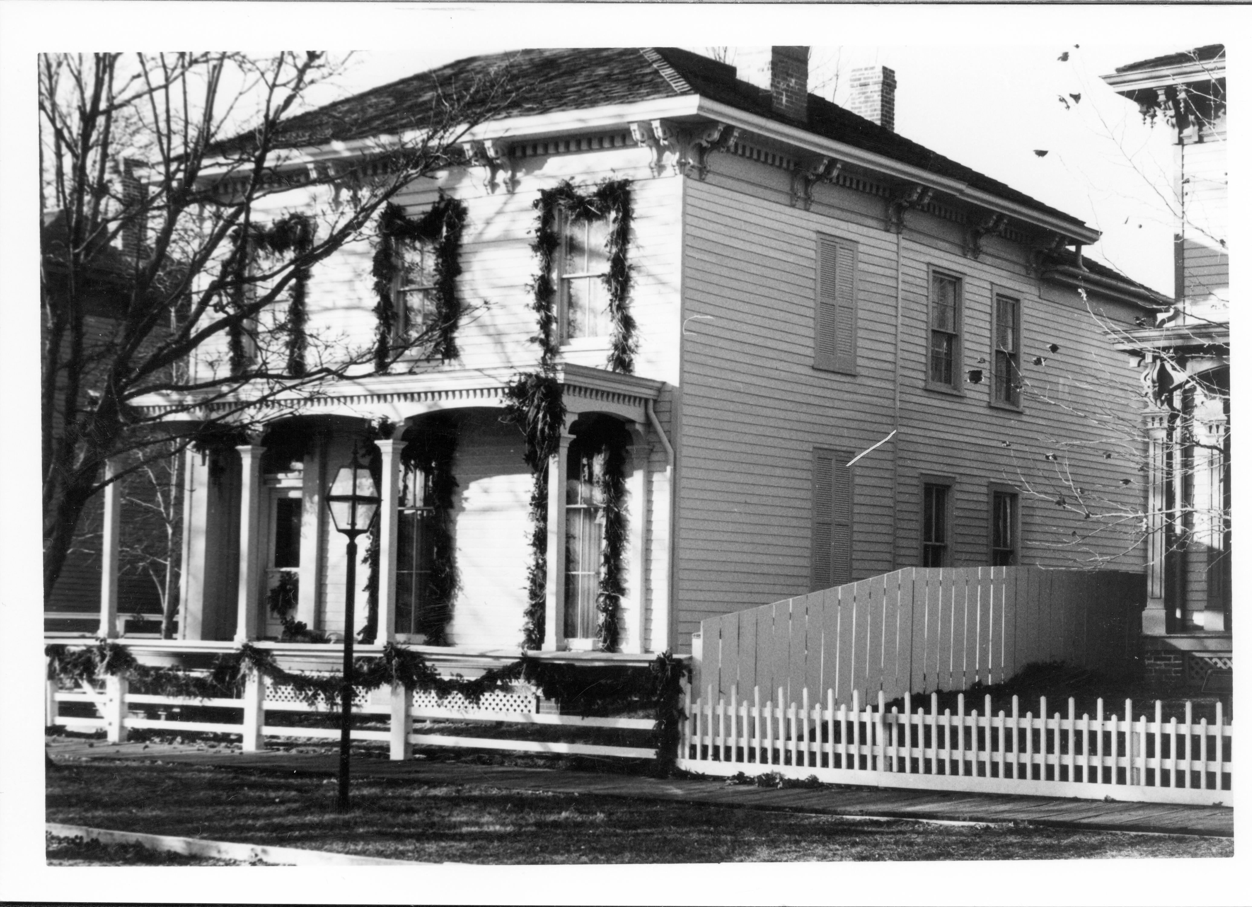 Lincoln Home NHS- Christmas in Lincoln Neighborhood Looking south west from 8th Street, Rosenwald house decorated for Christmas. Christmas, neighborhood, Rosenwald, Lyon, wreath, garland, porch, fence