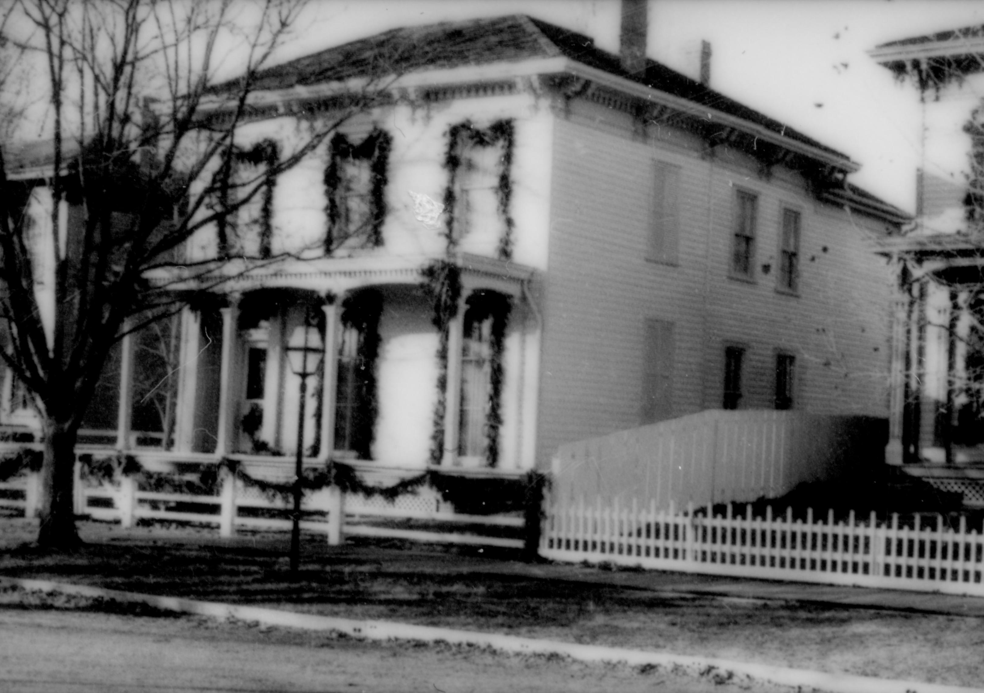 Lincoln Home NHS- Christmas in Lincoln Neighborhood Looking south west from 8th Street, Rosenwald house decorated for Christmas Christmas, neighborhood, Lyon, Rosenwald, wreath, garland, porch, fence, decor