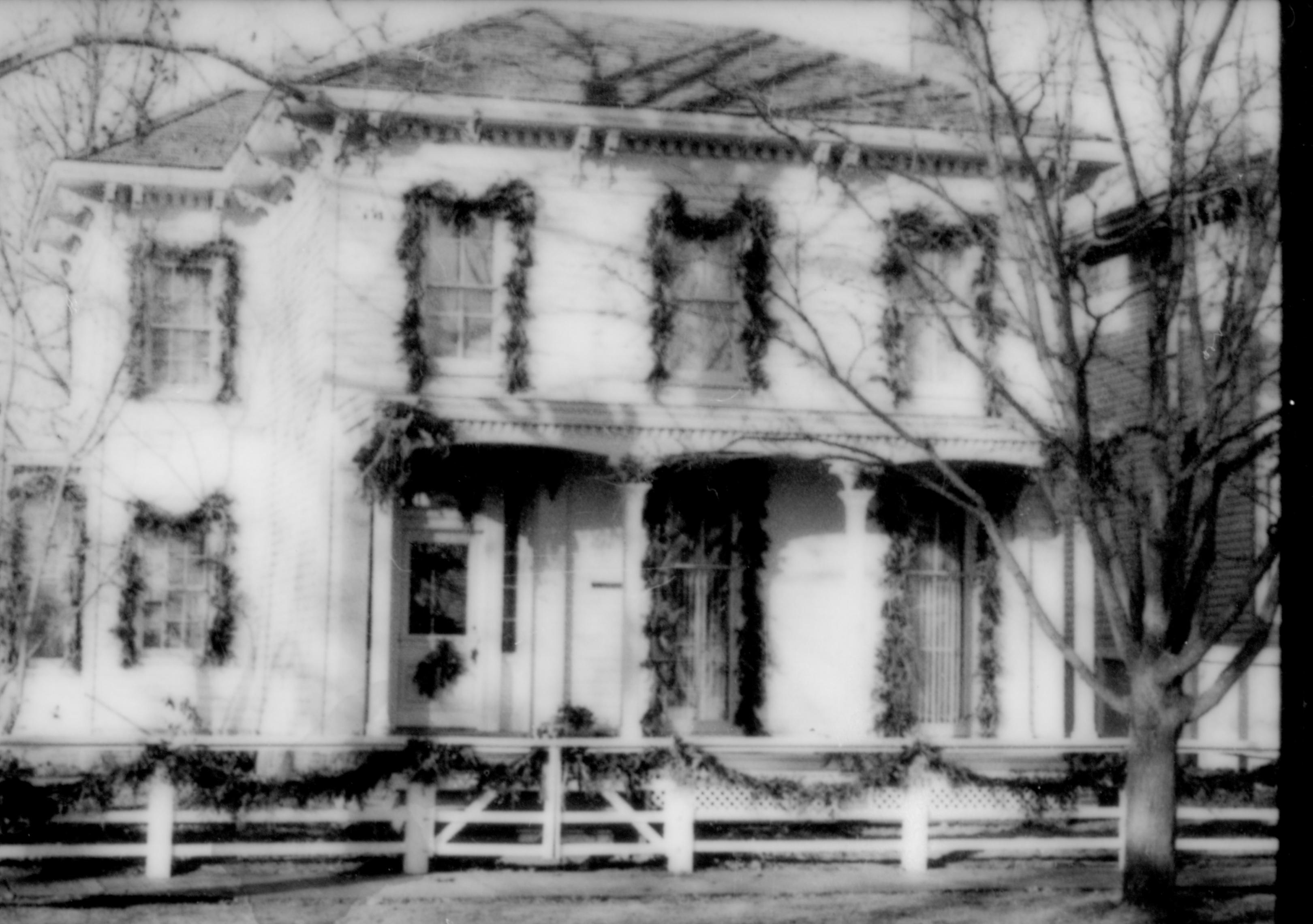 Lincoln Home NHS- Christmas in Lincoln Neighborhood Looking west from 8th Street, Rosenwald house decorated for Christmas. Christmas, neighborhood, Rosenwald, Lyon, decor, garland, wreath, porch, fence