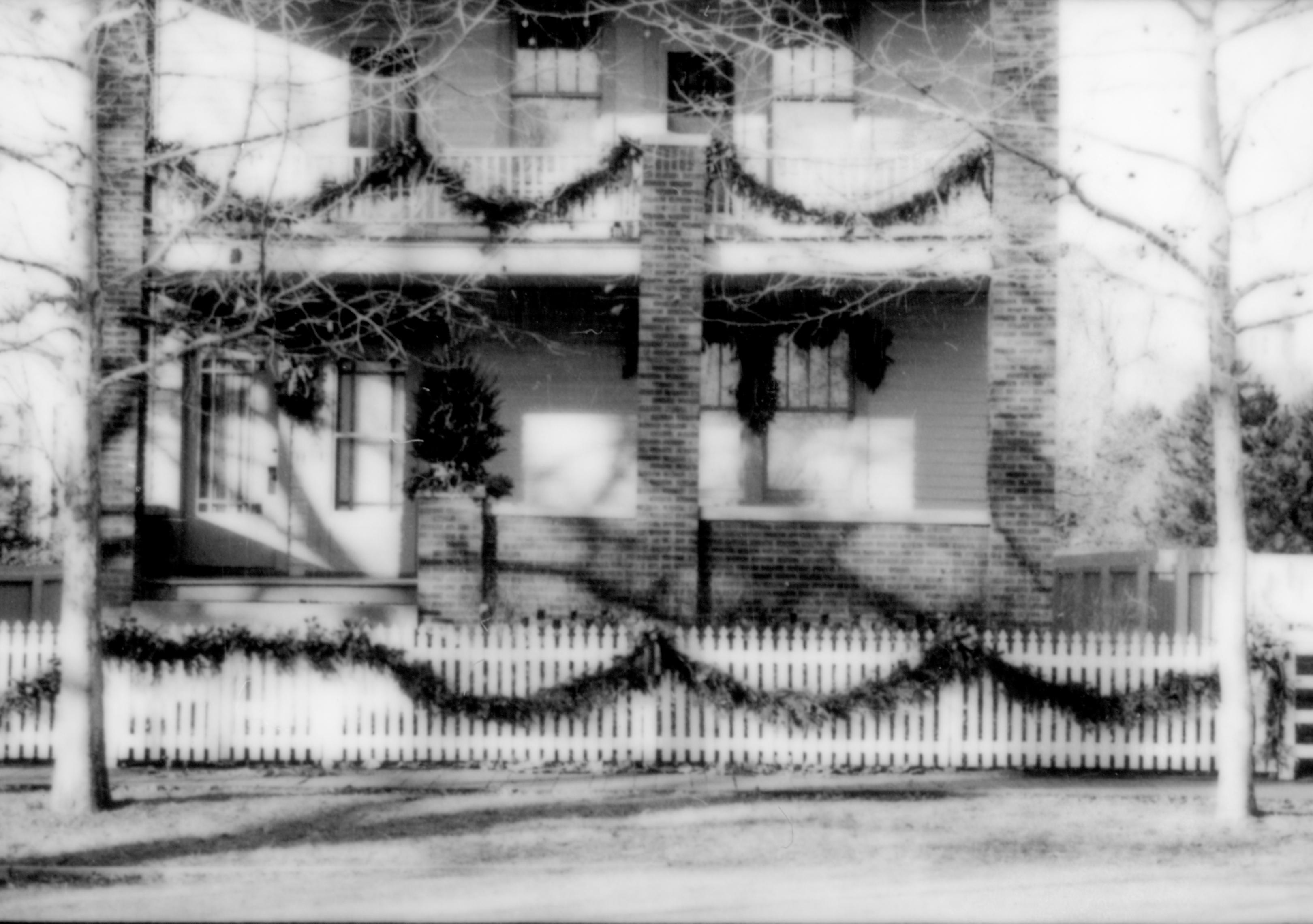 Lincoln Home NHS- Christmas in Lincoln Neighborhood Looking west from 8th Street, Sprigg house decorated for Christmas. Christmas, neighborhood, Sprigg, garland, wreath, fence, porch