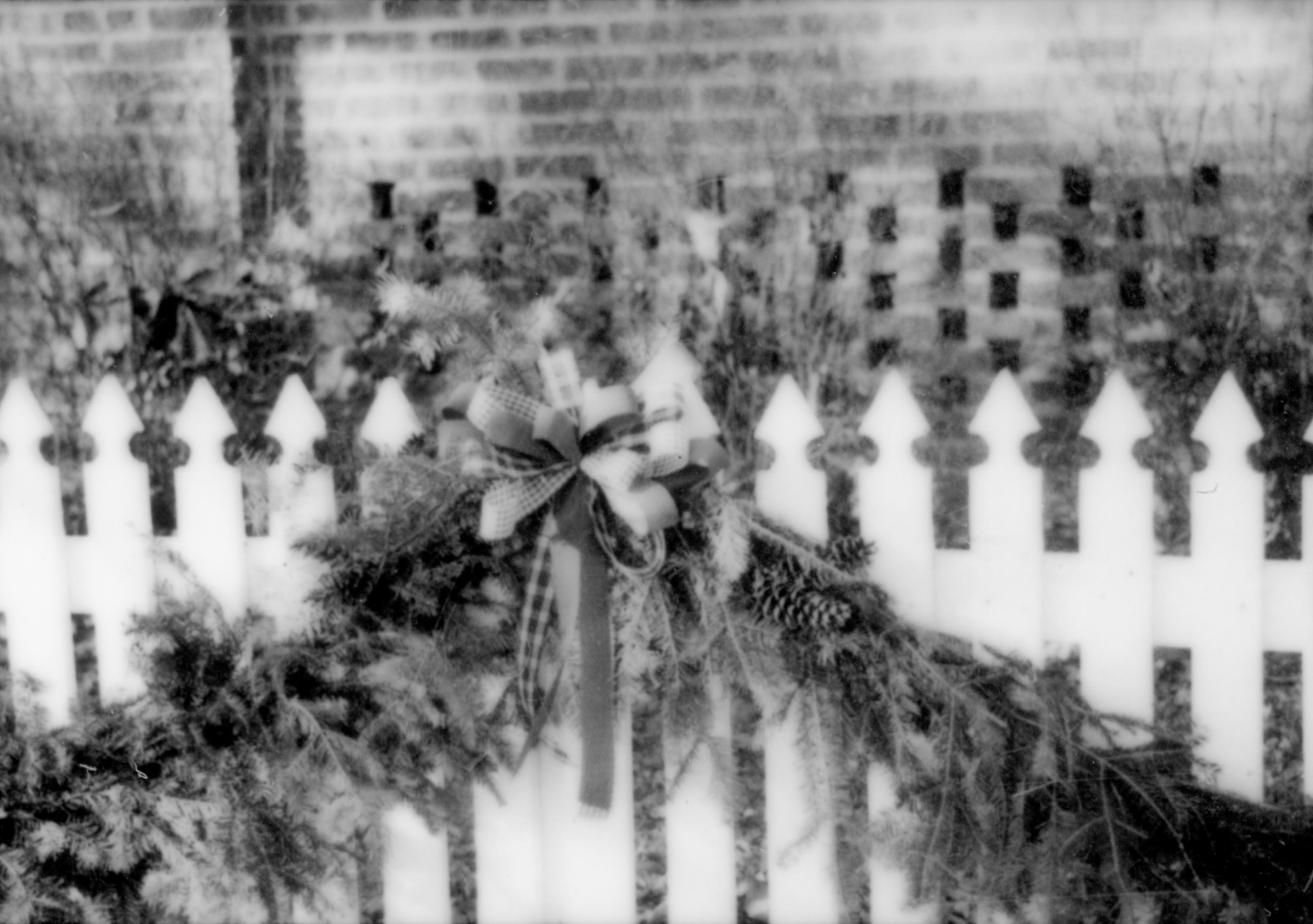 Lincoln Home NHS- Christmas in Lincoln Neighborhood Looking west from boardwalk, Sprigg house fence decorated for Christmas. Detail. Christmas, neighborhood, decorations, decor, fence, garland, Sprigg