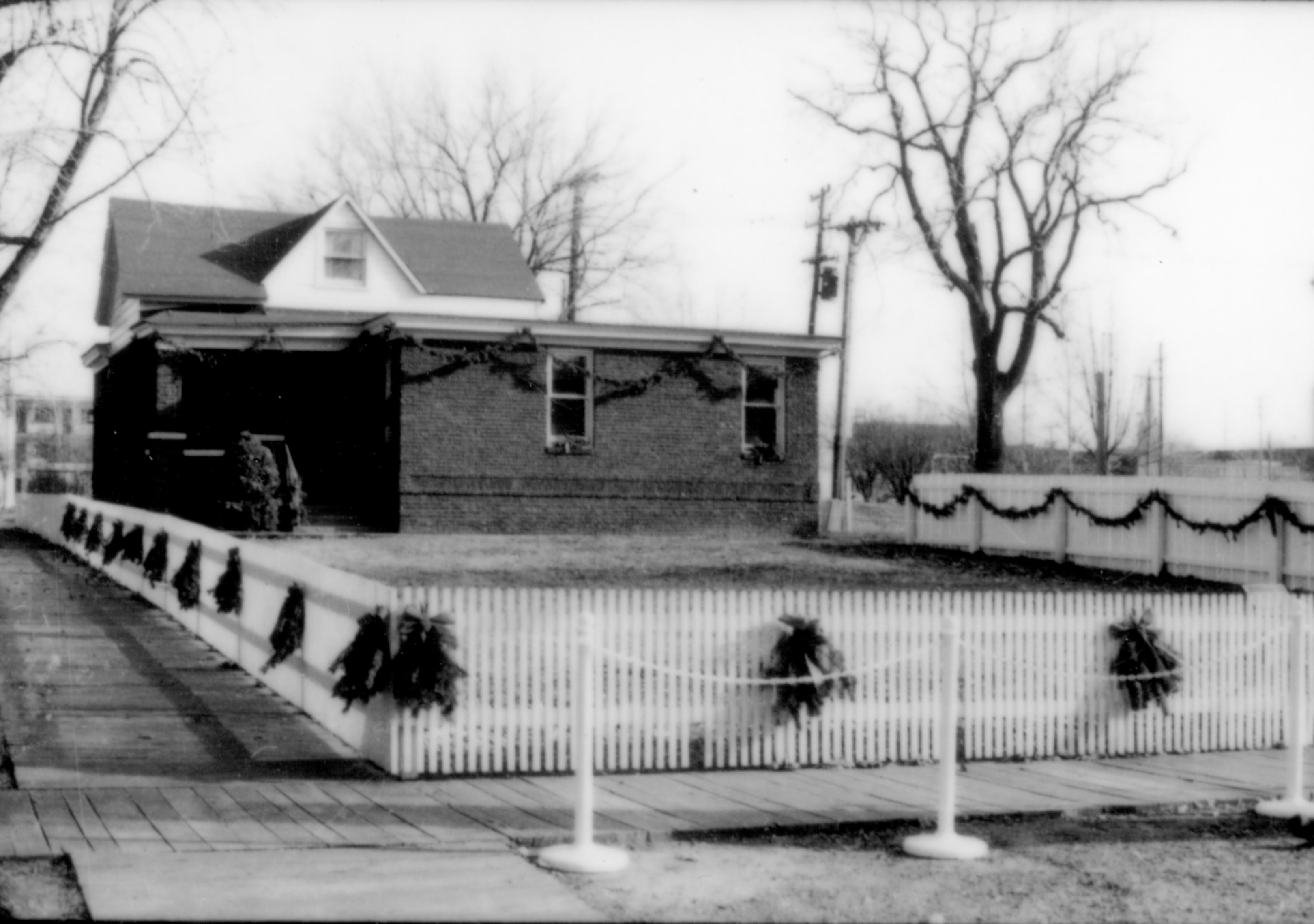 Lincoln Home NHS- Christmas in Lincoln Neighborhood Looking east from 8th Street, Arnold house decorated for Christmas. Christmas, neighborhood, decorations, Arnold, fence, decor, stanchion, wreath, garland