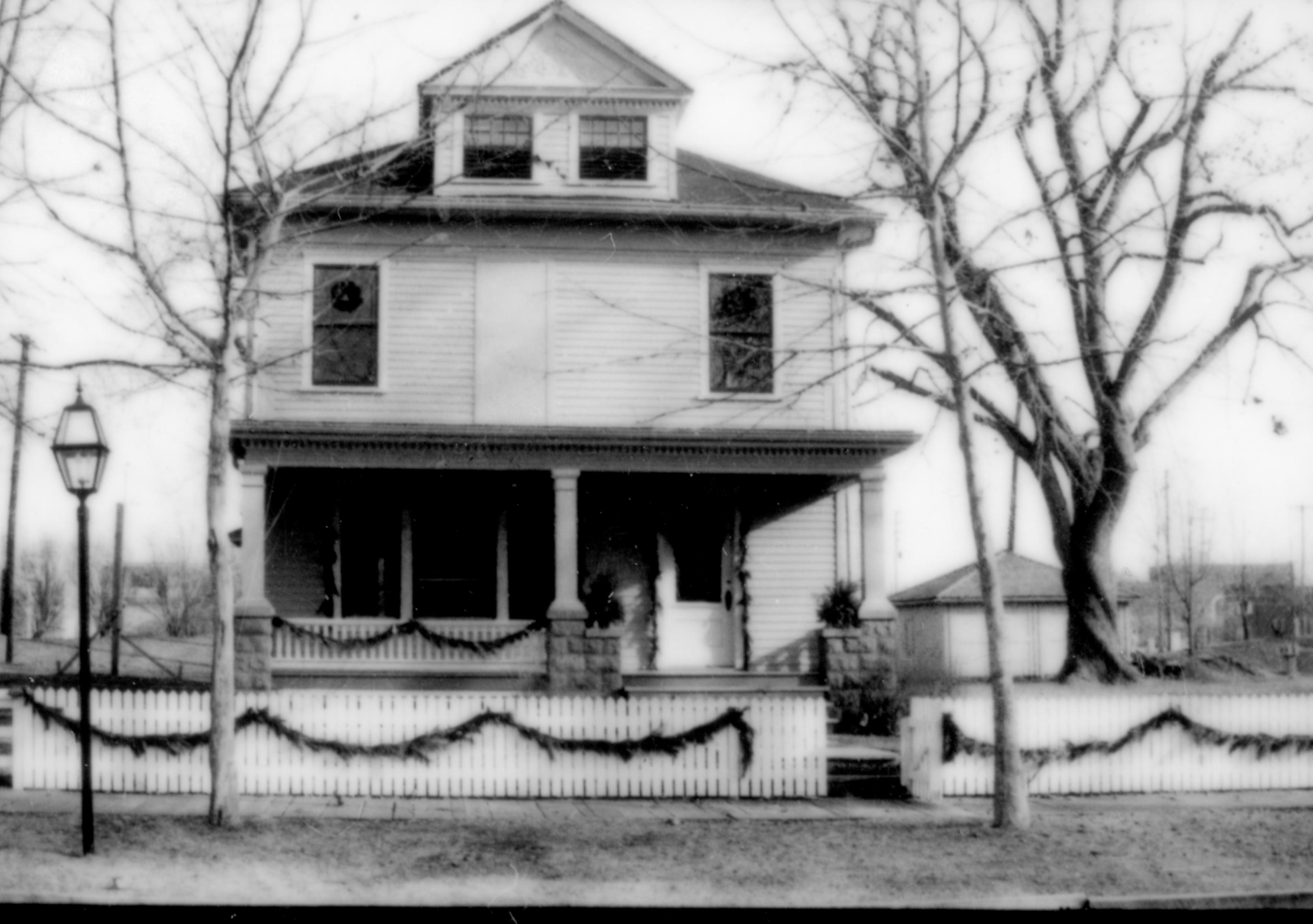 Lincoln Home NHS- Christmas in Lincoln Neighborhood Looking east from 8th Street, Cook house decorated for Christmas. Christmas, neighborhood, decorations, fence, porch, wreath, garland