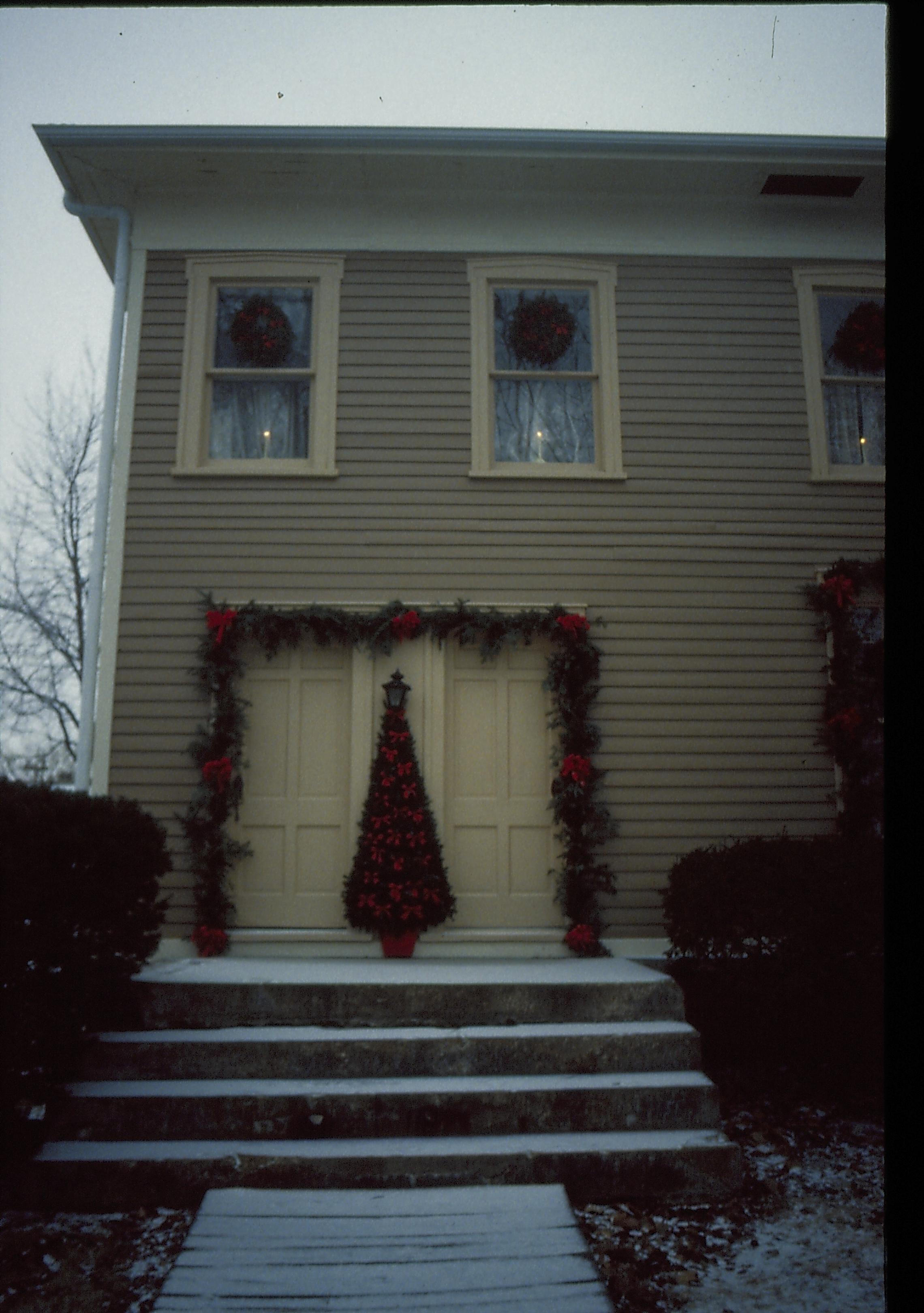 Lincoln Home NHS- Christmas in Lincoln Neighborhood Looking west from boardwalk, Christmas decor on east doors and face of Miller house.  Christmas, decorations, decor, Miller, garland, wreath