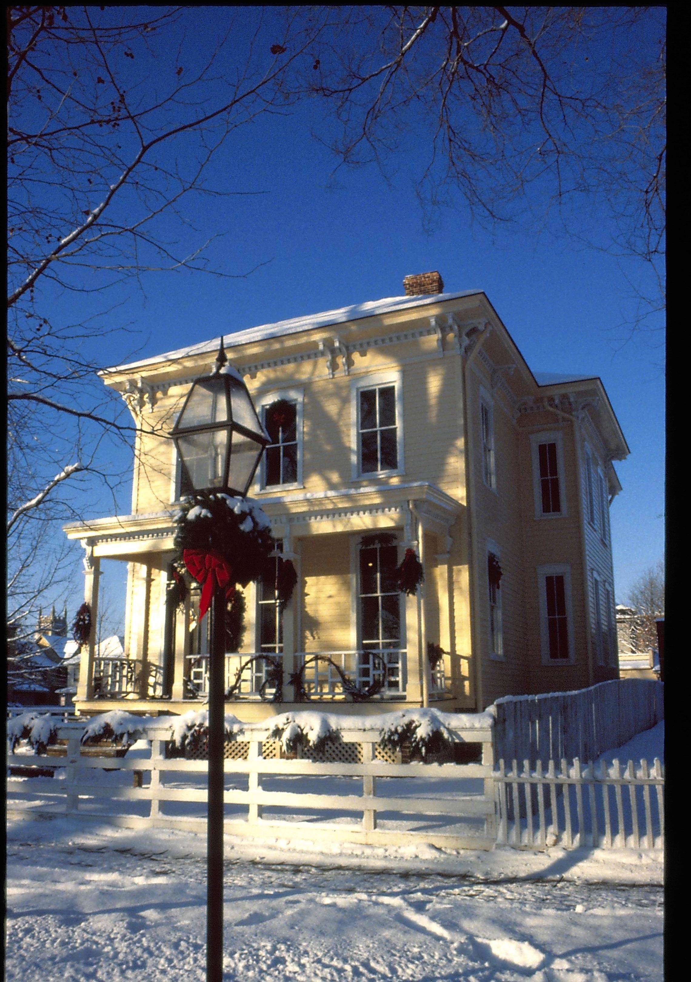 Lincoln Home NHS- Christmas in Lincoln Neighborhood Looking south west from 8th Street, light post decorated for Christmas, Shutt house in background. Christmas, decorations, post, garland, Shutt