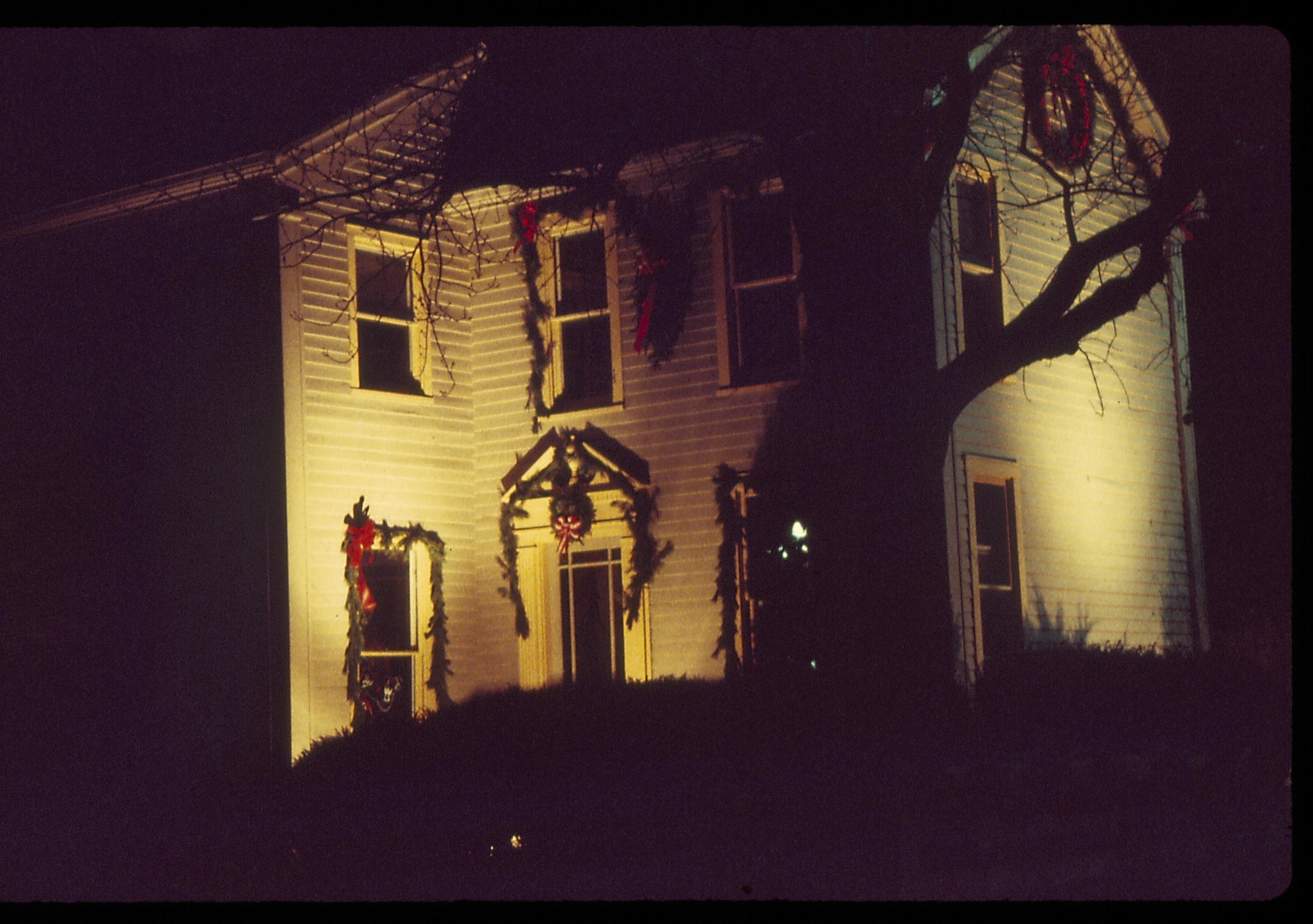 Lincoln Home NHS- Christmas in Lincoln Neighborhood Looking south east (?), Morse house decorated for Christmas. Night. Christmas, decorations, night, Morse, wreath, garland