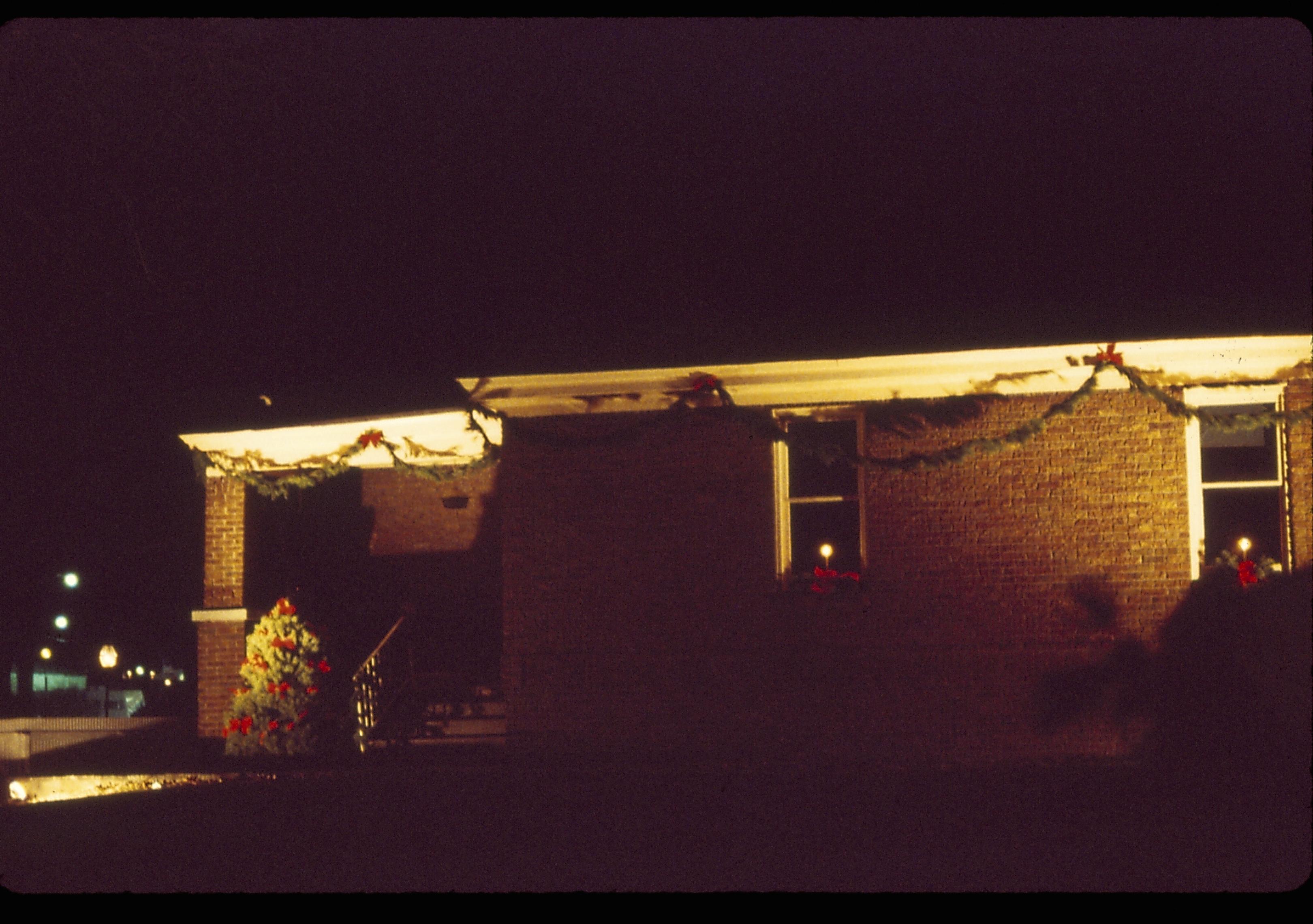 Lincoln Home NHS- Christmas in Lincoln Neighborhood Looking north east from west yard, the Arnold house decorated for Christmas. Night. Christmas, decorations, night, wreath, garland, night, Arnold