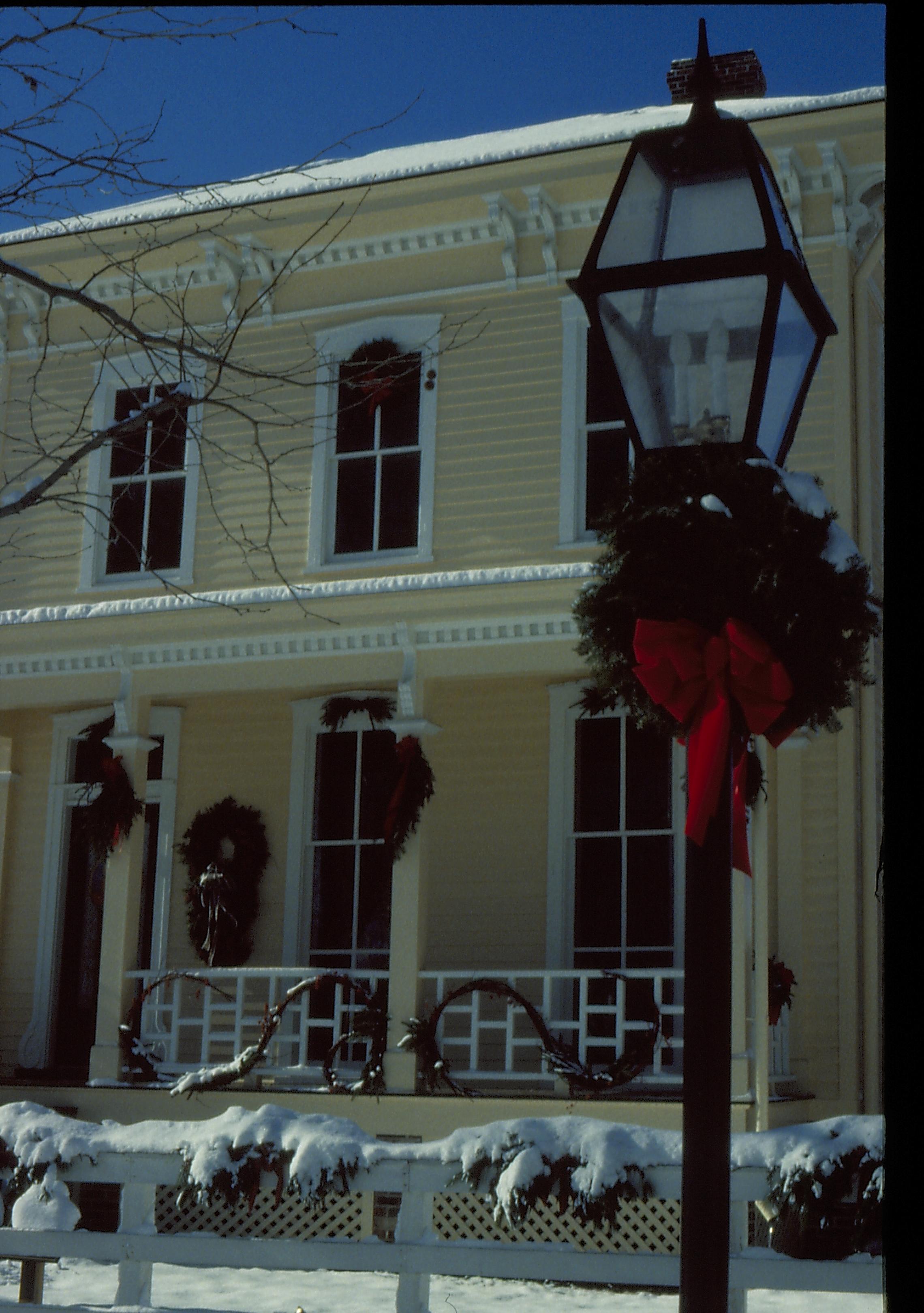 Lincoln Home NHS- Christmas in Lincoln Neighborhood Looking south west from boardwalk, Shutt house decorated for Christmas. Post in foreground. Christmas, decorations, post, Shutt, wreath, garland, snow