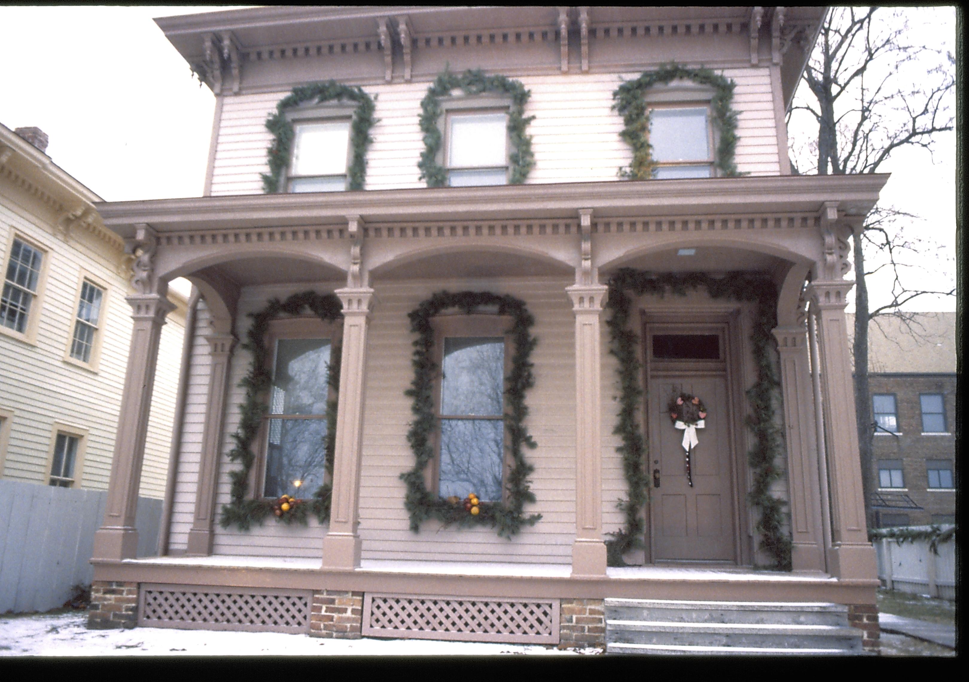 Lincoln Home NHS- Christmas in Lincoln Neighborhood Looking west from boardwalk, Beedle house decorated for Christmas. Christmas, decorations, Beedle, decor, garland, wreath, porch, snow