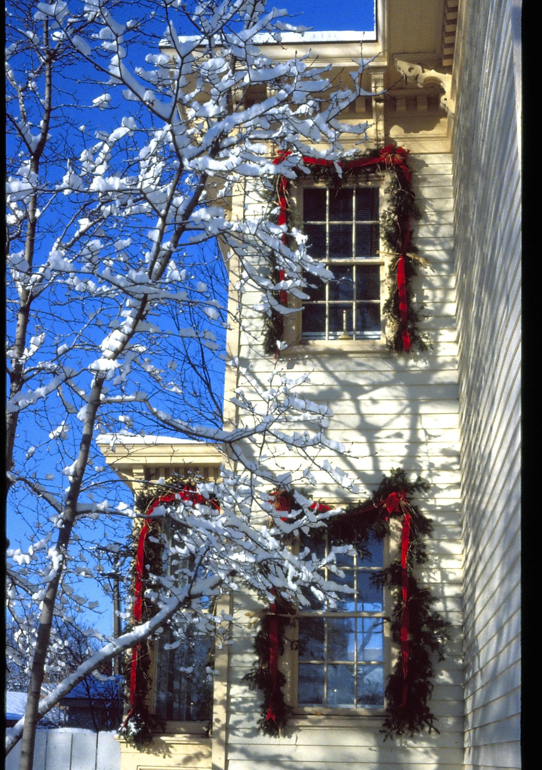 Lincoln Home NHS- Christmas in Lincoln Neighborhood Looking west from yard, Shutt house decorated for Christmas. Detail. Christmas, decorations, wreath, garland, Shutt, snow, detail.