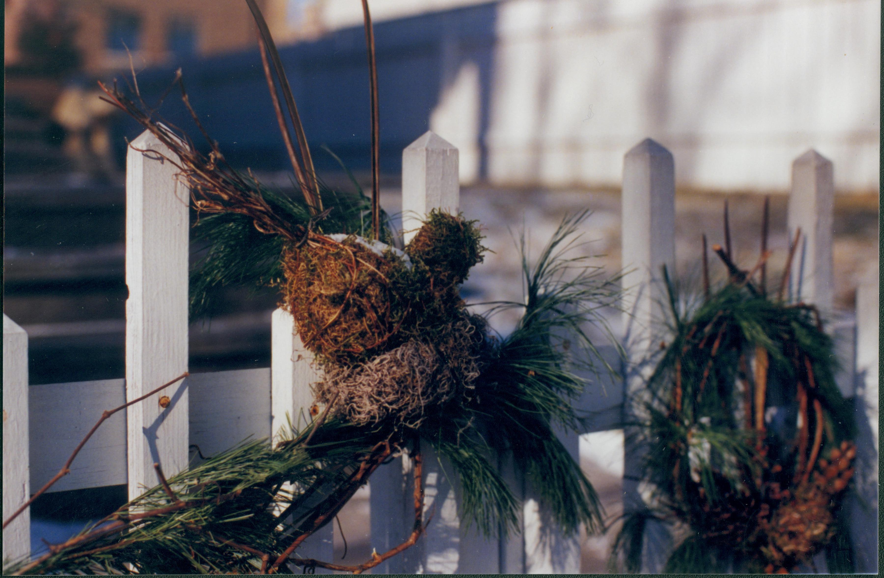 Lincoln Home NHS- Christmas in Lincoln Neighborhood Looking northwest from 8th Street boardwalk toward decorations on Beedle house east fence. Detail. Christmas, neighborhood, Beedle, wreath, decoration, fence