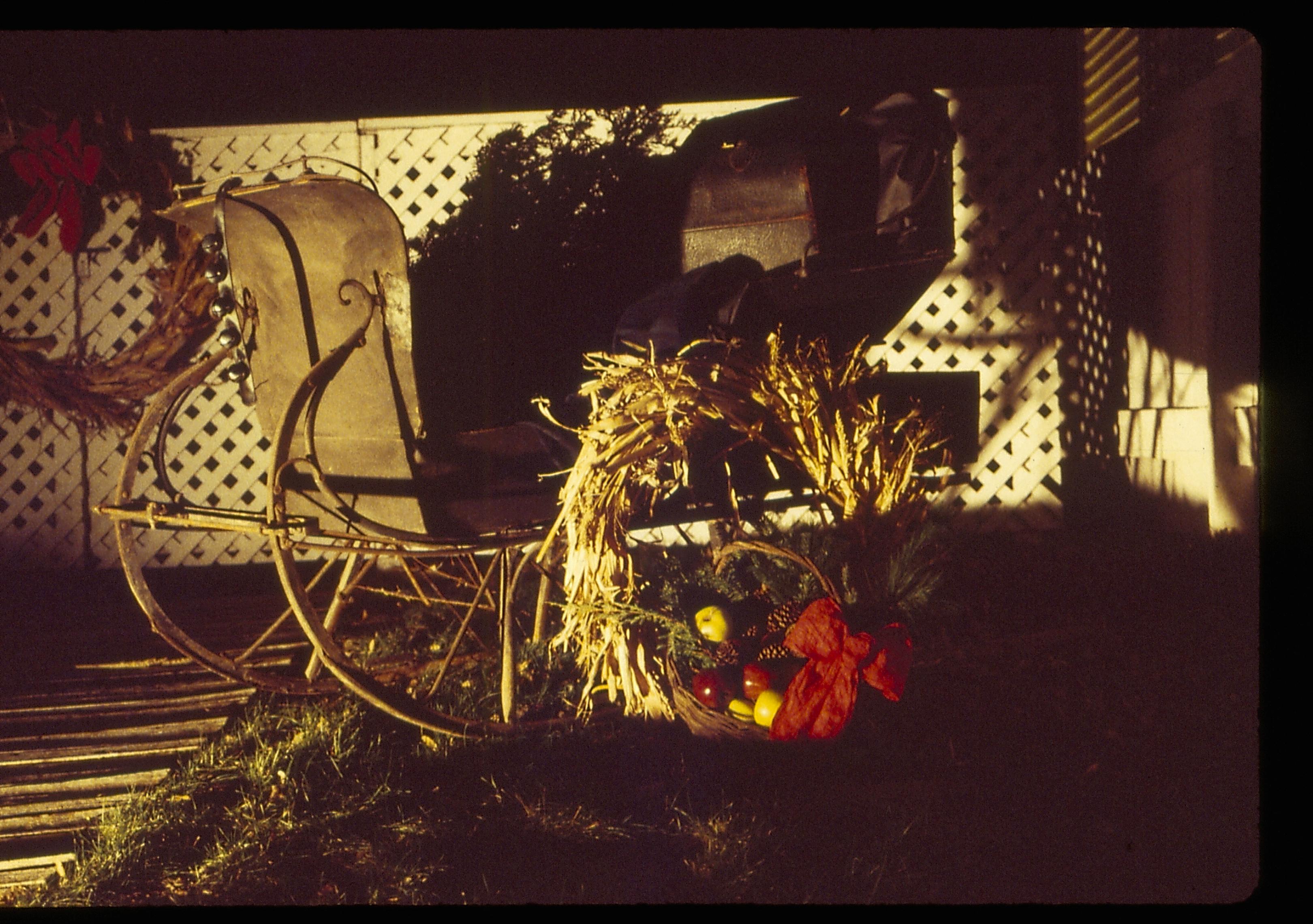 Lincoln Home NHS- Christmas in Lincoln Neighborhood Looking east, Christmas decor in Corneau house yard. Night. Detail. Christmas, decorations, sleigh, night, Corneau, yard, wreath, garland