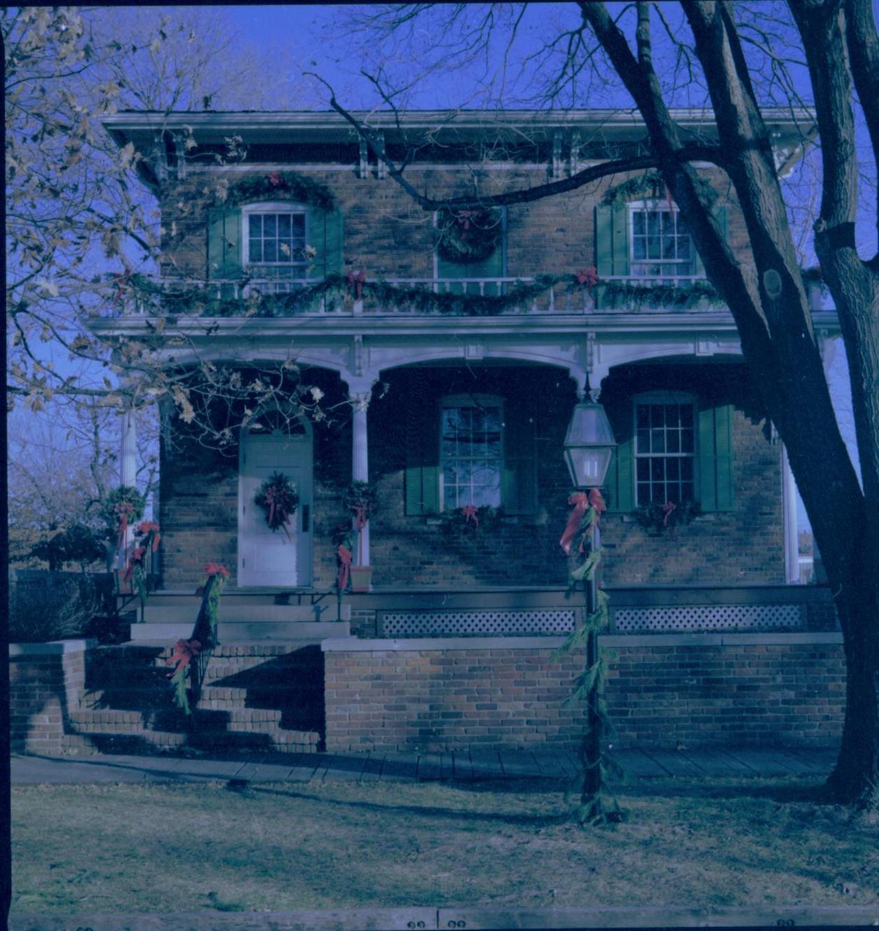 Lincoln Home NHS- Christmas in Lincoln Neighborhood Looking east from 8th Street, west face of Conference Center decorated for Christmas. Christmas, decorations, Conference, center, decor, garland, wreath, porch